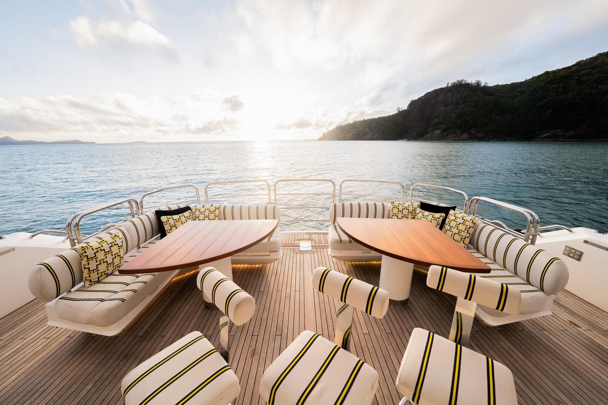Luxurious Sunseeker 115 Sport Yacht deck with stylish seating, overlooking serene ocean view.