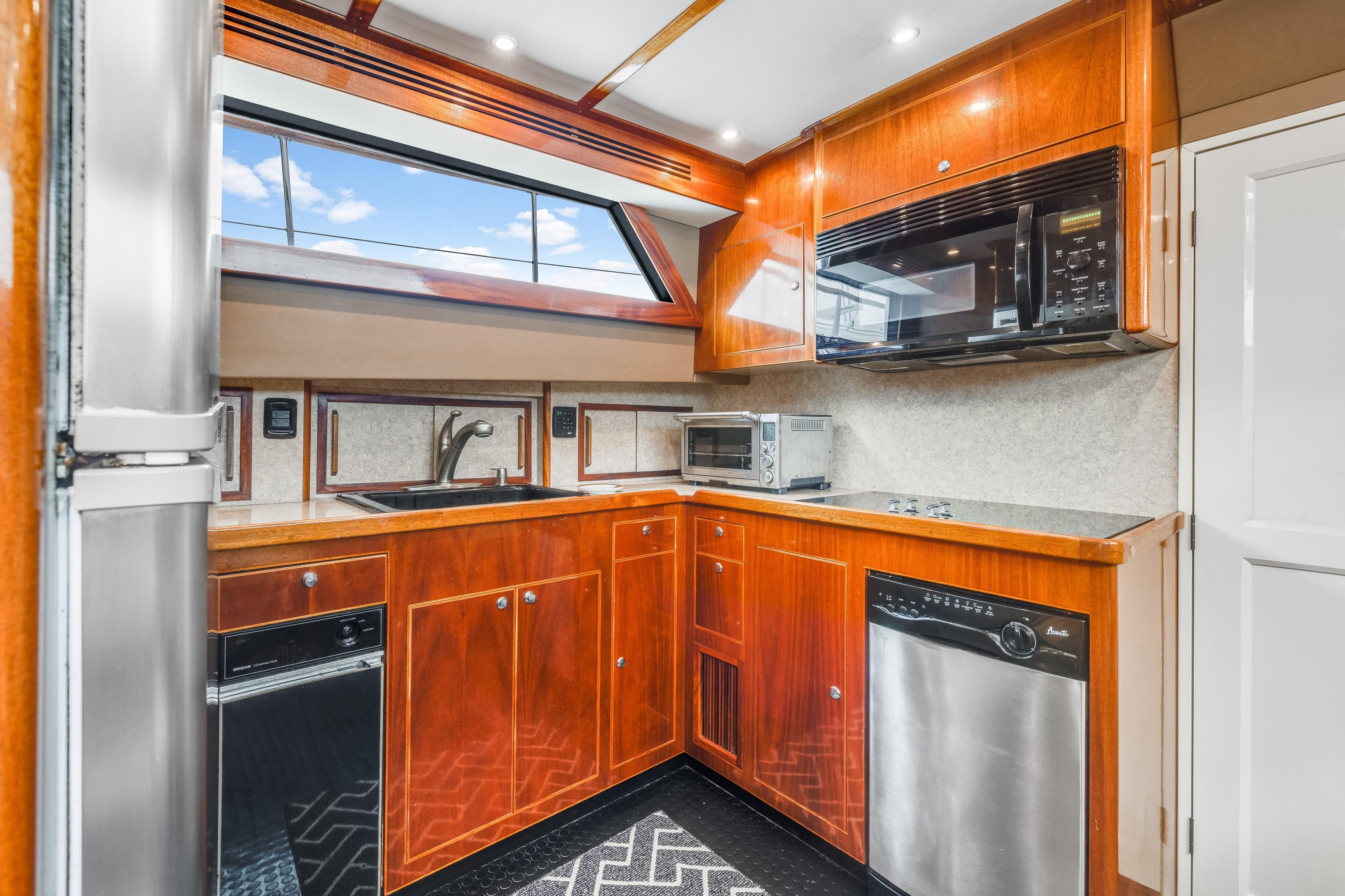 Luxurious kitchen interior of 1980 Hatteras 53 Motor Yacht with modern appliances.