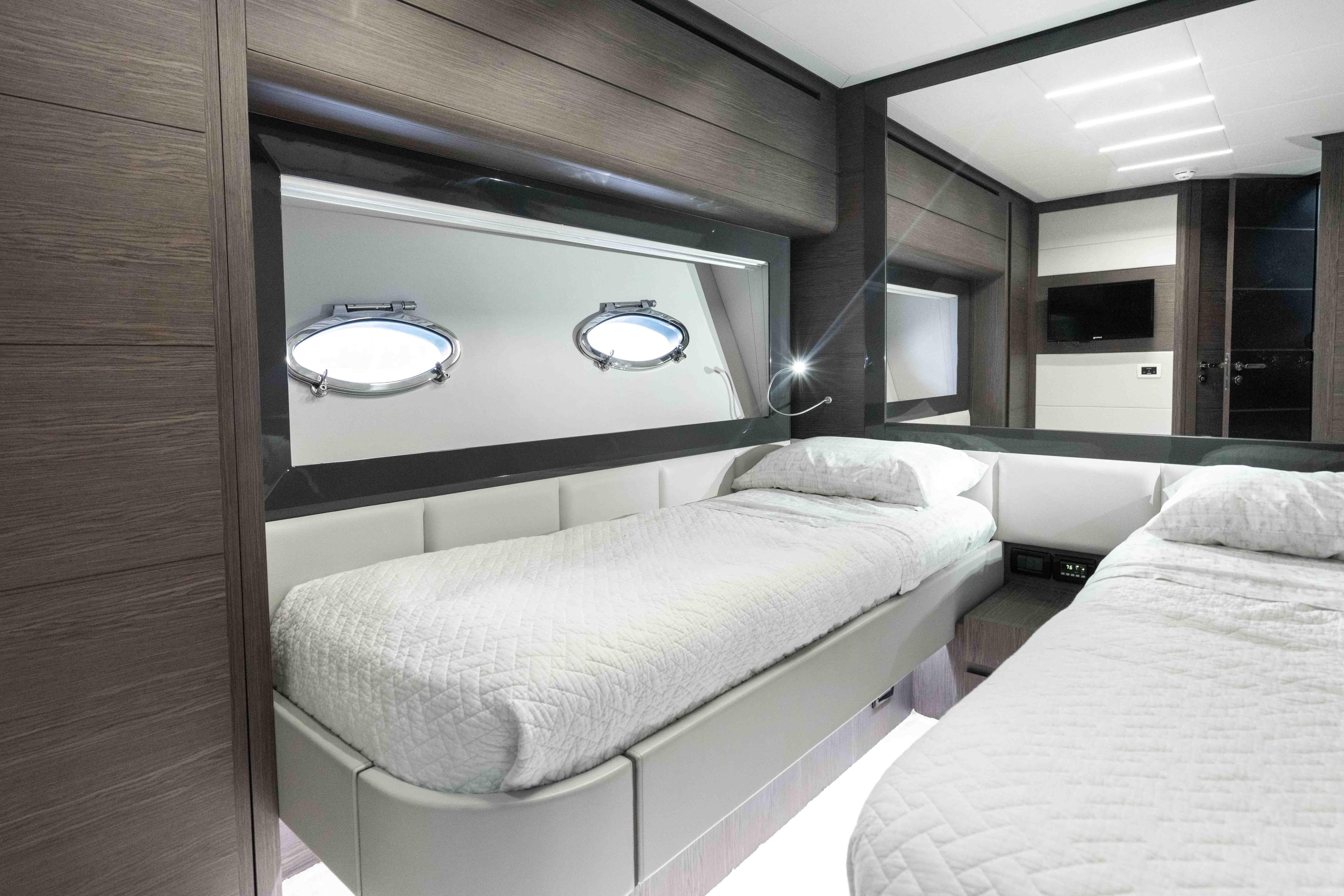 Luxurious twin cabin interior on 2017 Pershing 74 yacht with modern design.