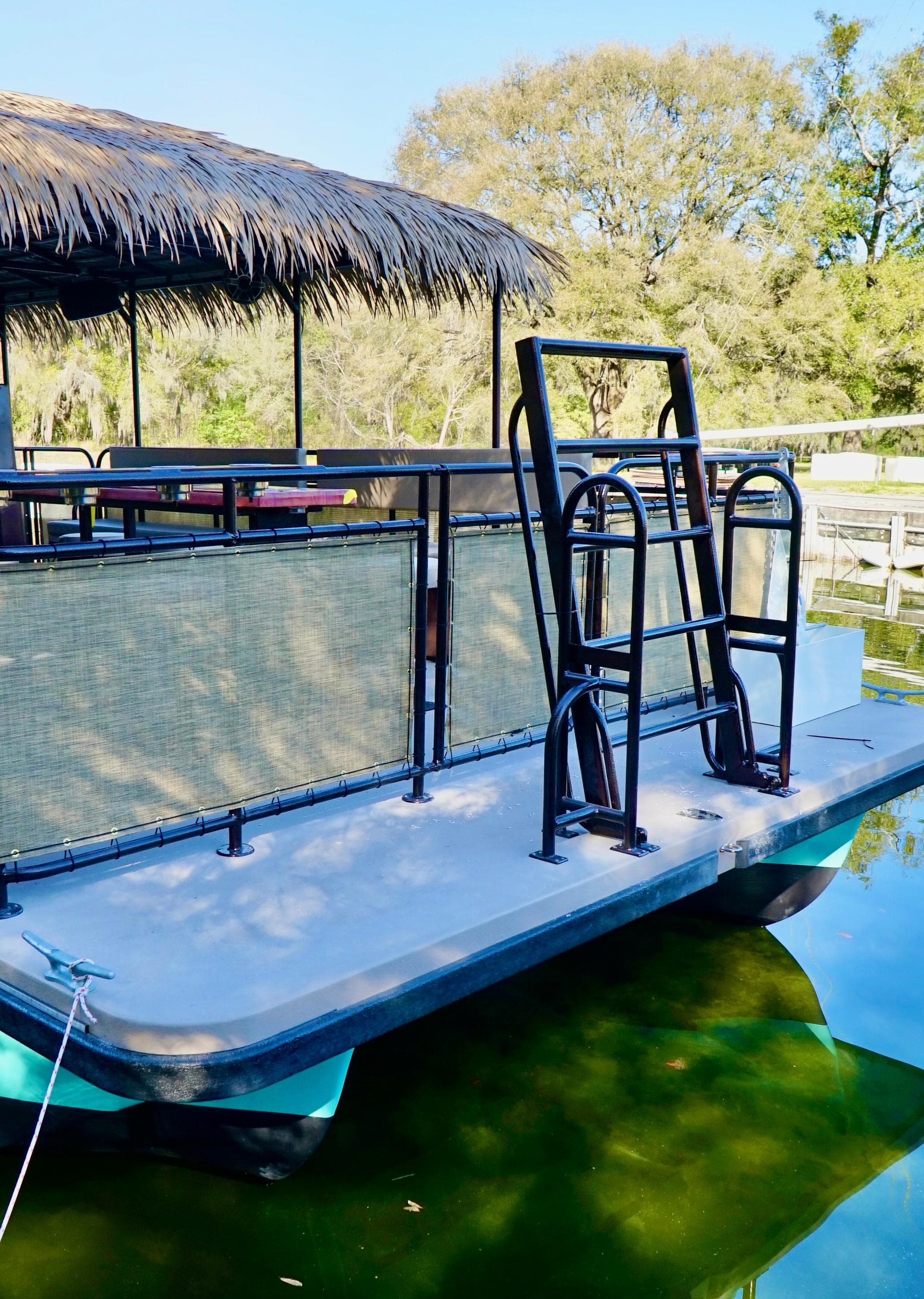 2024 A&M Manufacturing BullDog 34 pontoon boat with ladder and canopy.