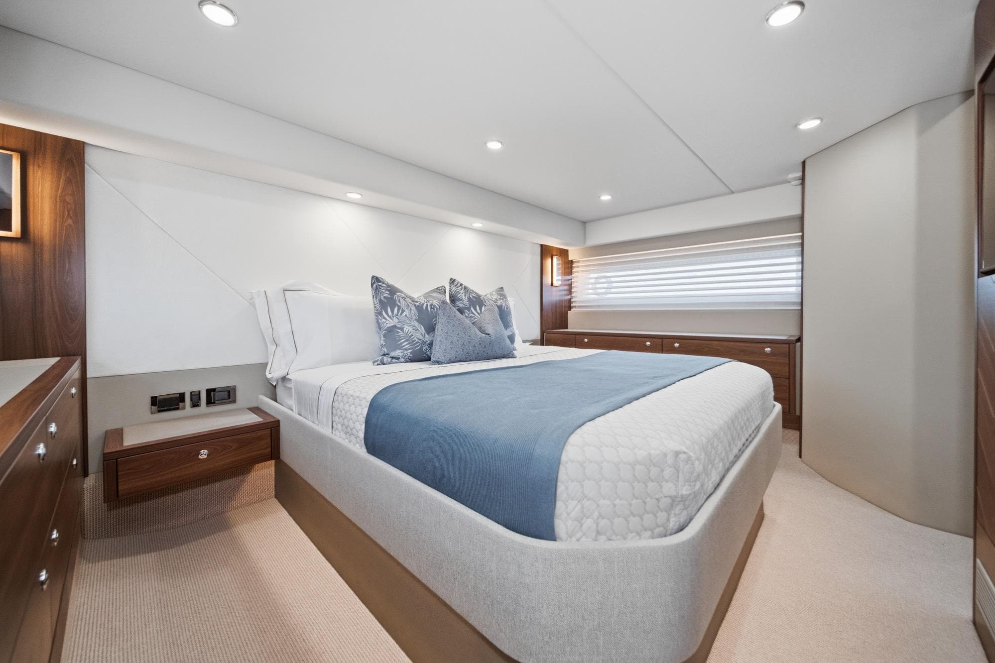Luxurious bedroom interior of 2026 Maritimo M55 yacht with modern design and elegant furnishings.