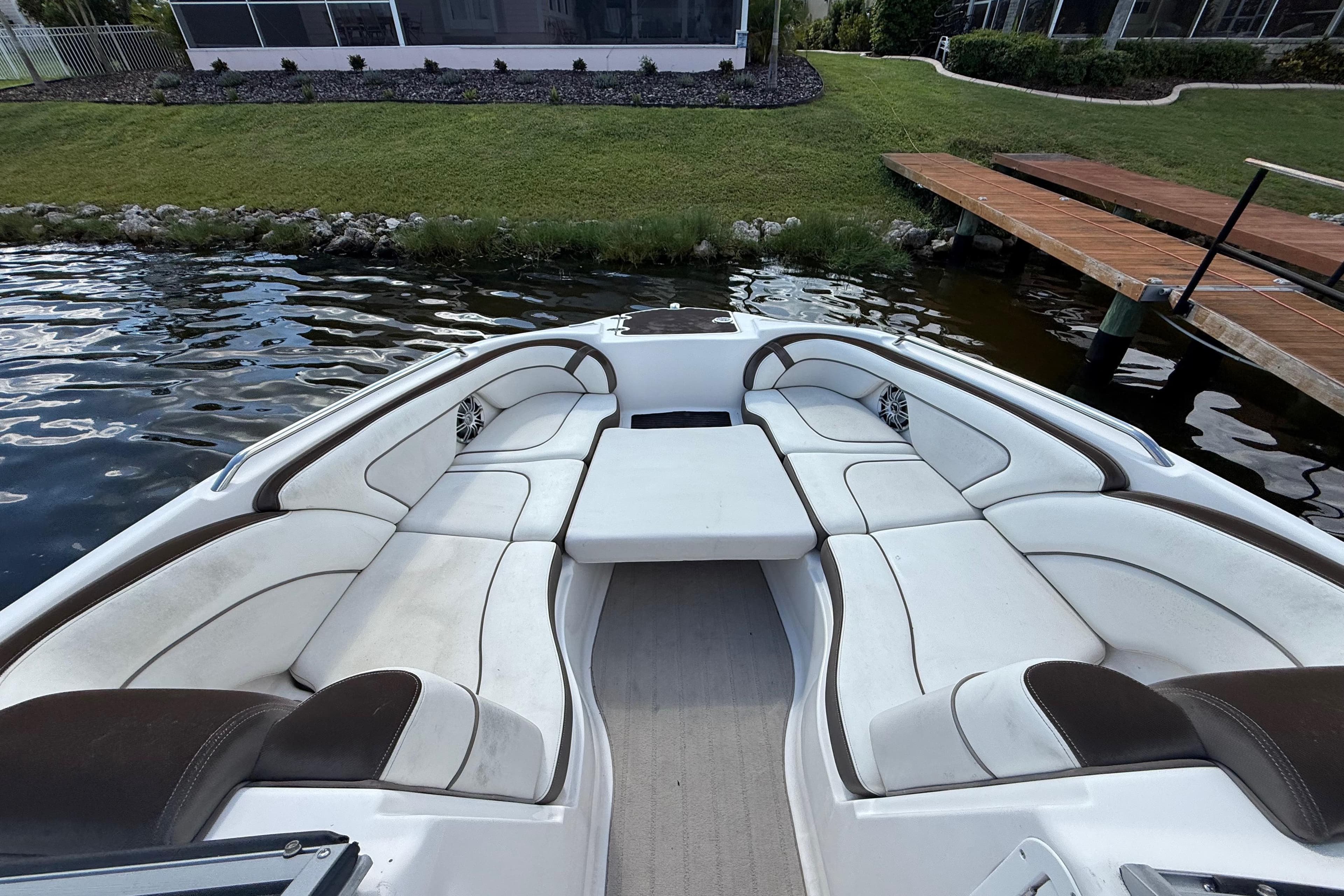 2014 Yamaha Boats 242 Limited S interior with white seating, dockside view.
