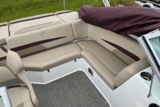 2021 Hurricane SunDeck 187 IO boat interior with beige seating and maroon accents.