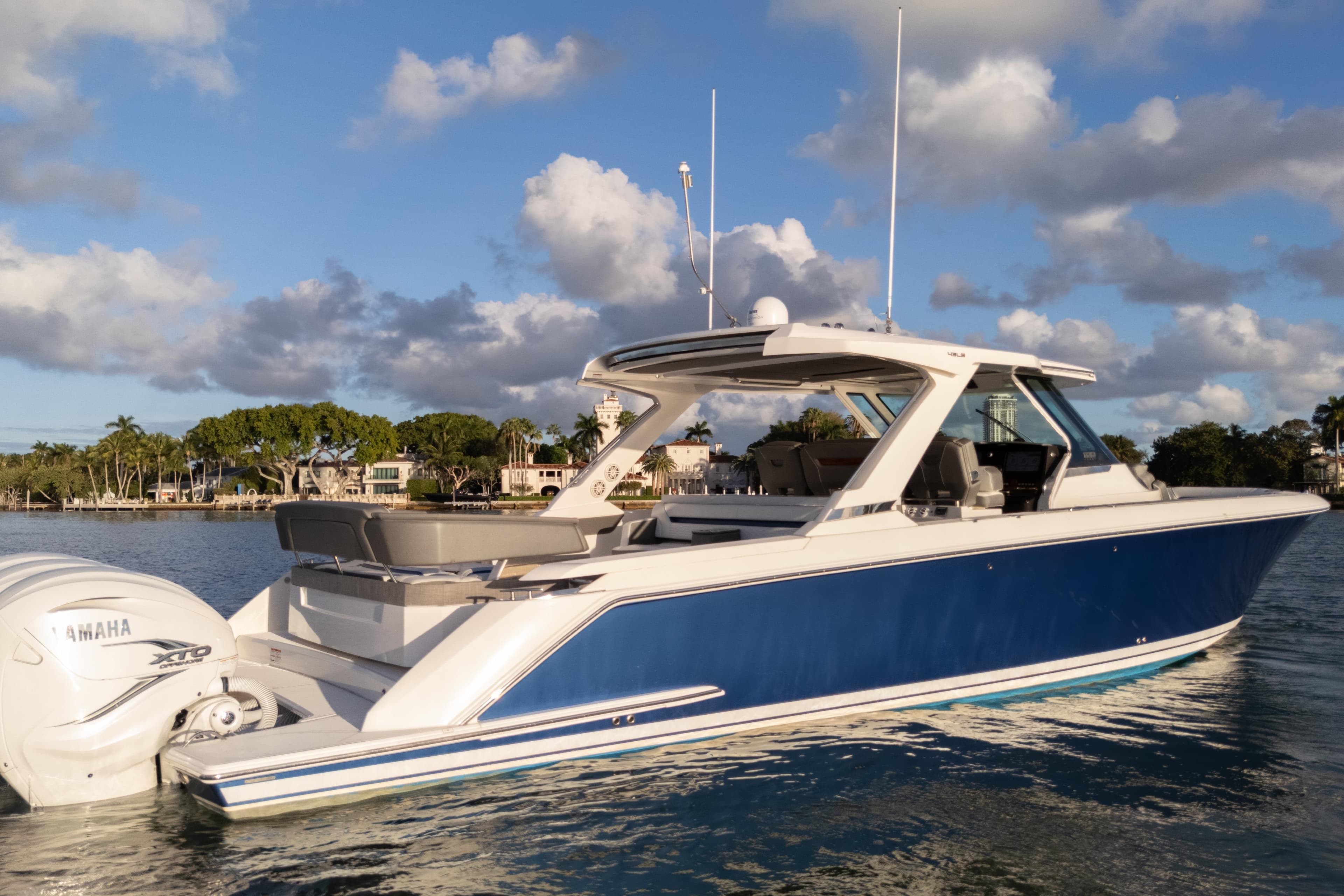 2020 Tiara Yachts 43 LS in water, blue hull, Yamaha engines, scenic background.