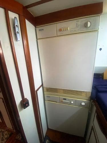 1989 Irwin 54 yacht interior with built-in appliance, wooden trim, and compact design.