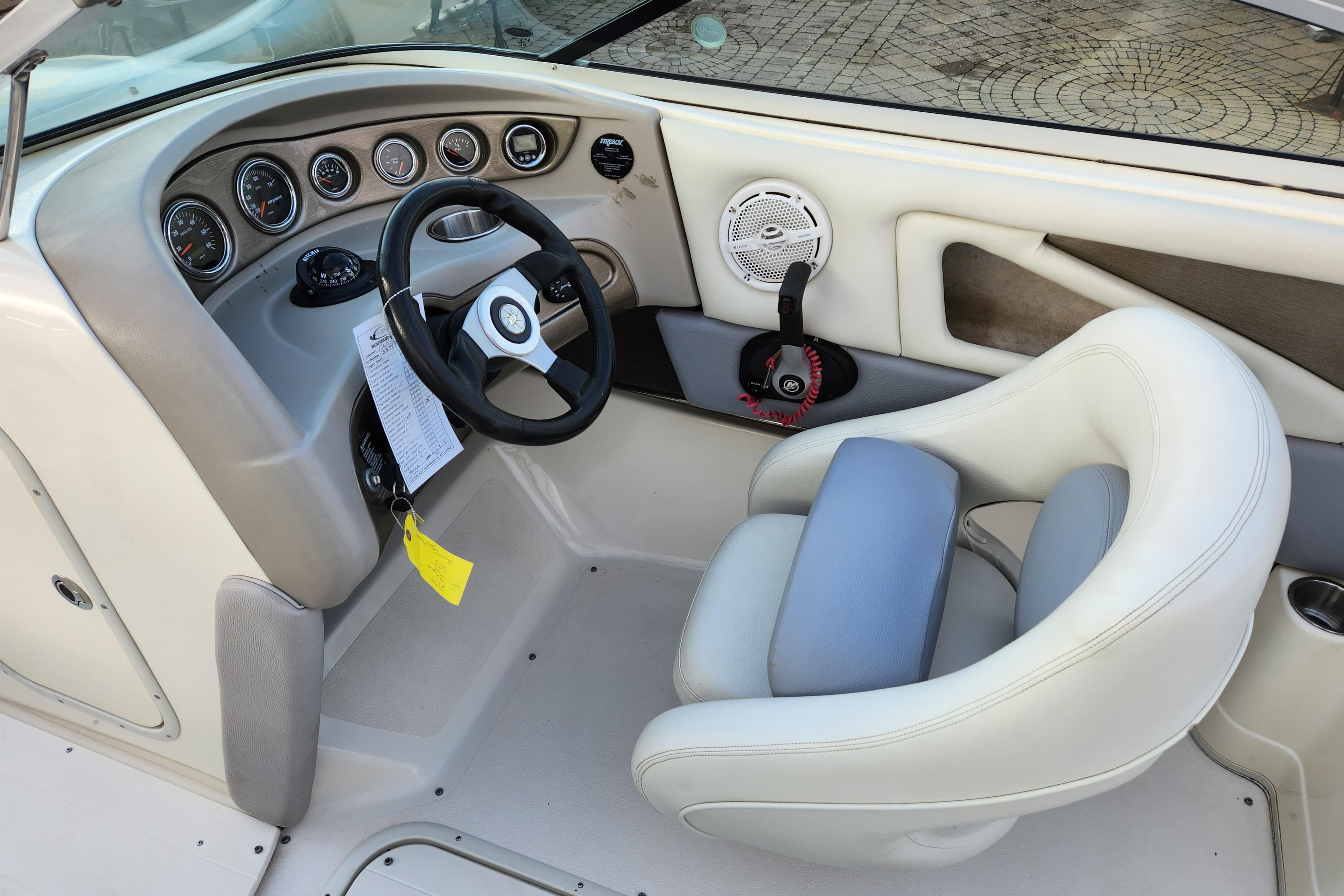 Interior of a 2009 Bryant 233 boat featuring steering wheel and dashboard controls.