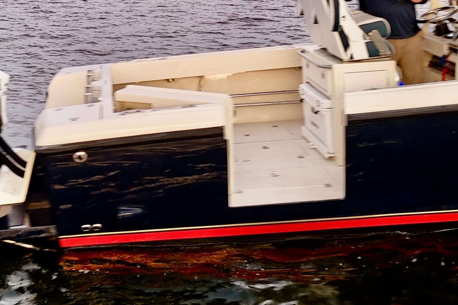 2003 Intrepid 289 Center Console boat on water, featuring sleek design and spacious seating.