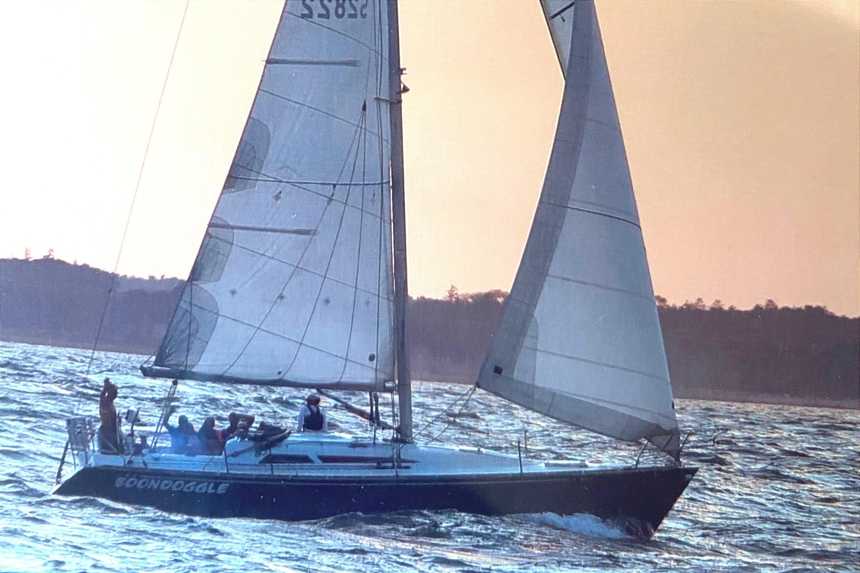 Sailboat "Boondoggle" on water at sunset, C&C 110 model, 2001.