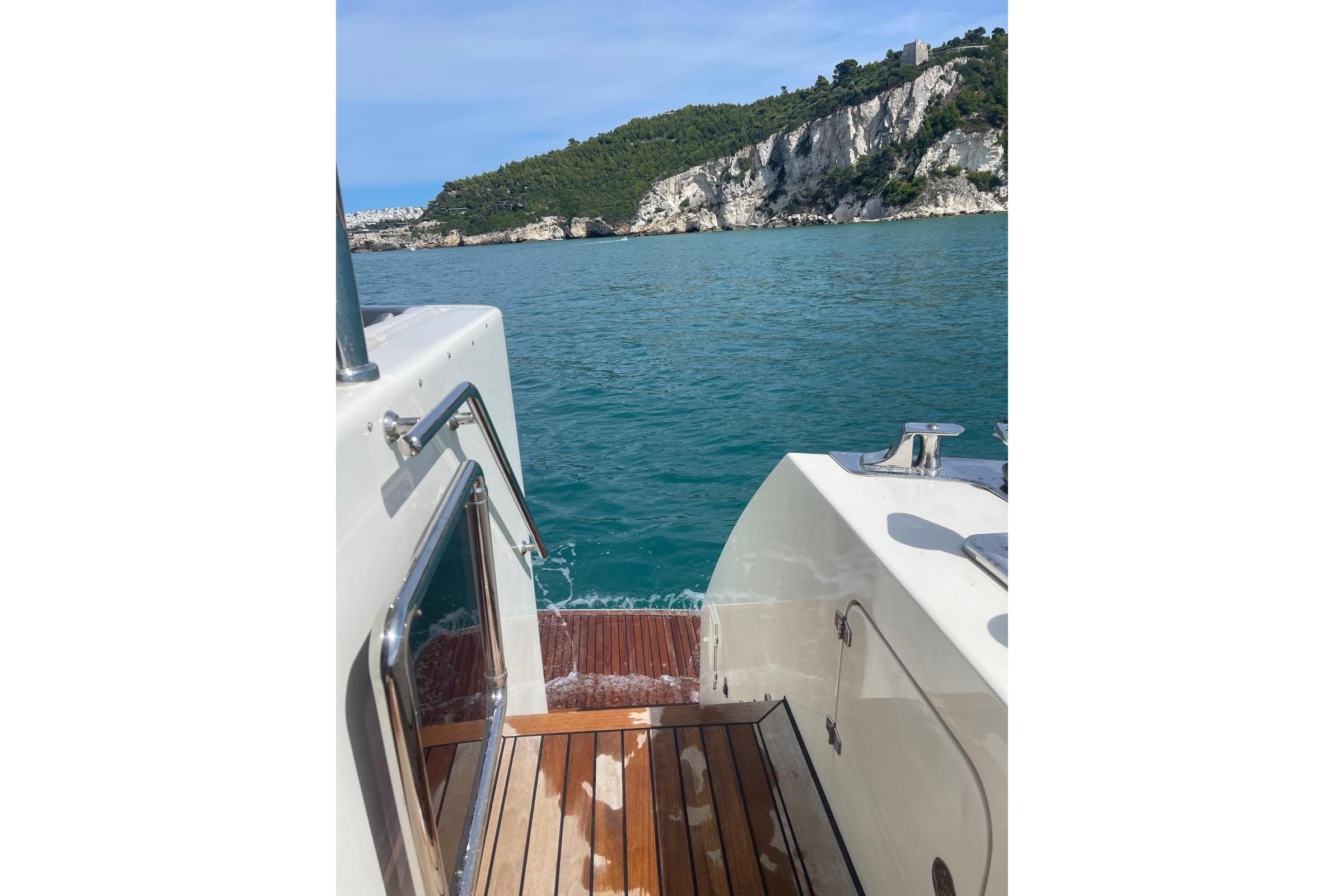 YENER TEKNE Ynr 63 boat, 2019 model, cruising near rocky coastline with clear blue water.