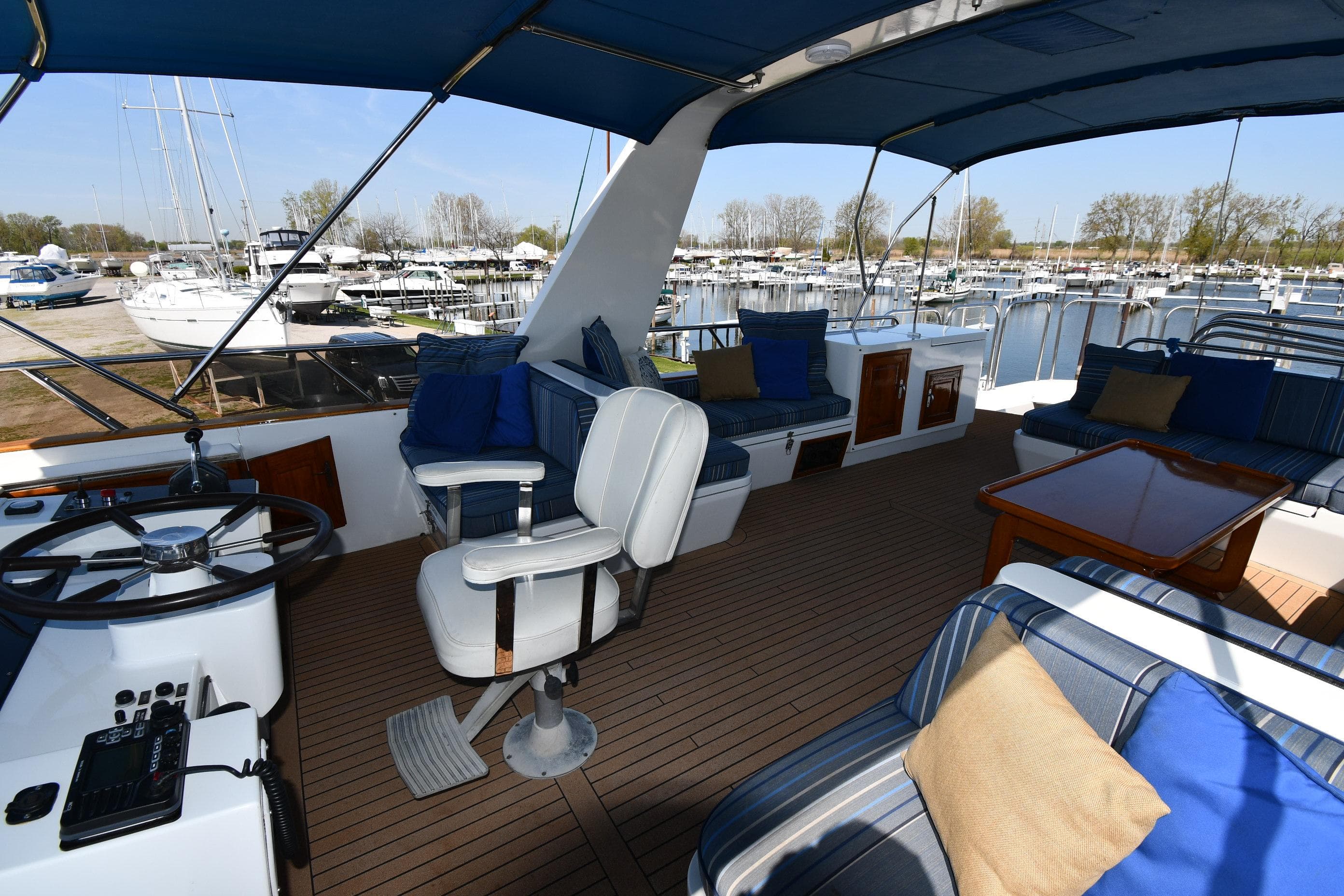 Interior of 1986 Lowland 64 Pilot House Long Range Motor Yacht with seating and helm.