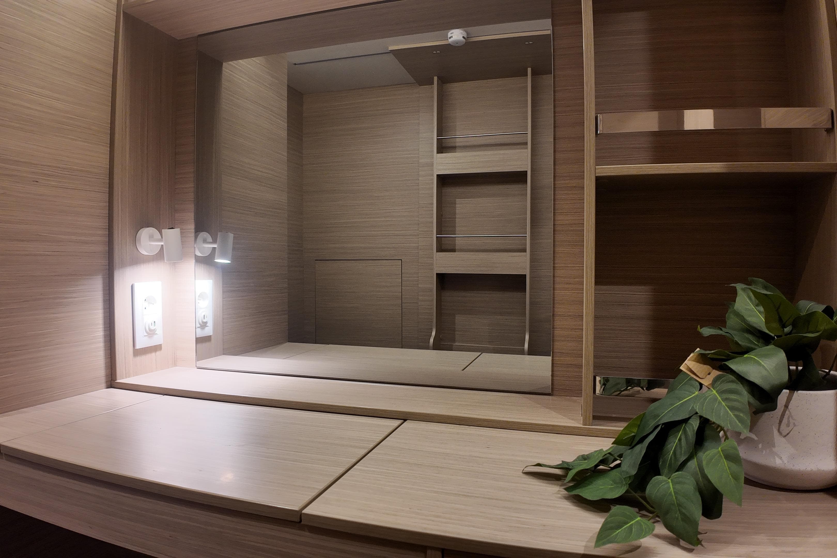 Modern interior of Lagoon 38 yacht, featuring wooden cabinetry and decorative plant, 2026 model.
