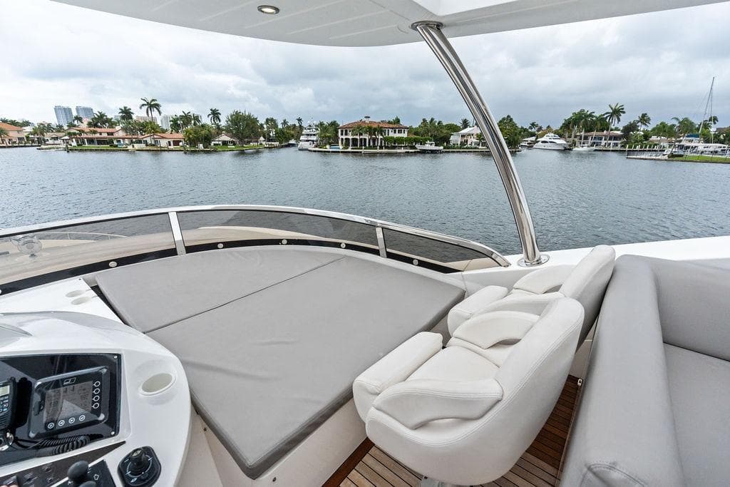 Luxurious Sunseeker 88 Yacht 2012 with spacious deck overlooking waterfront homes.