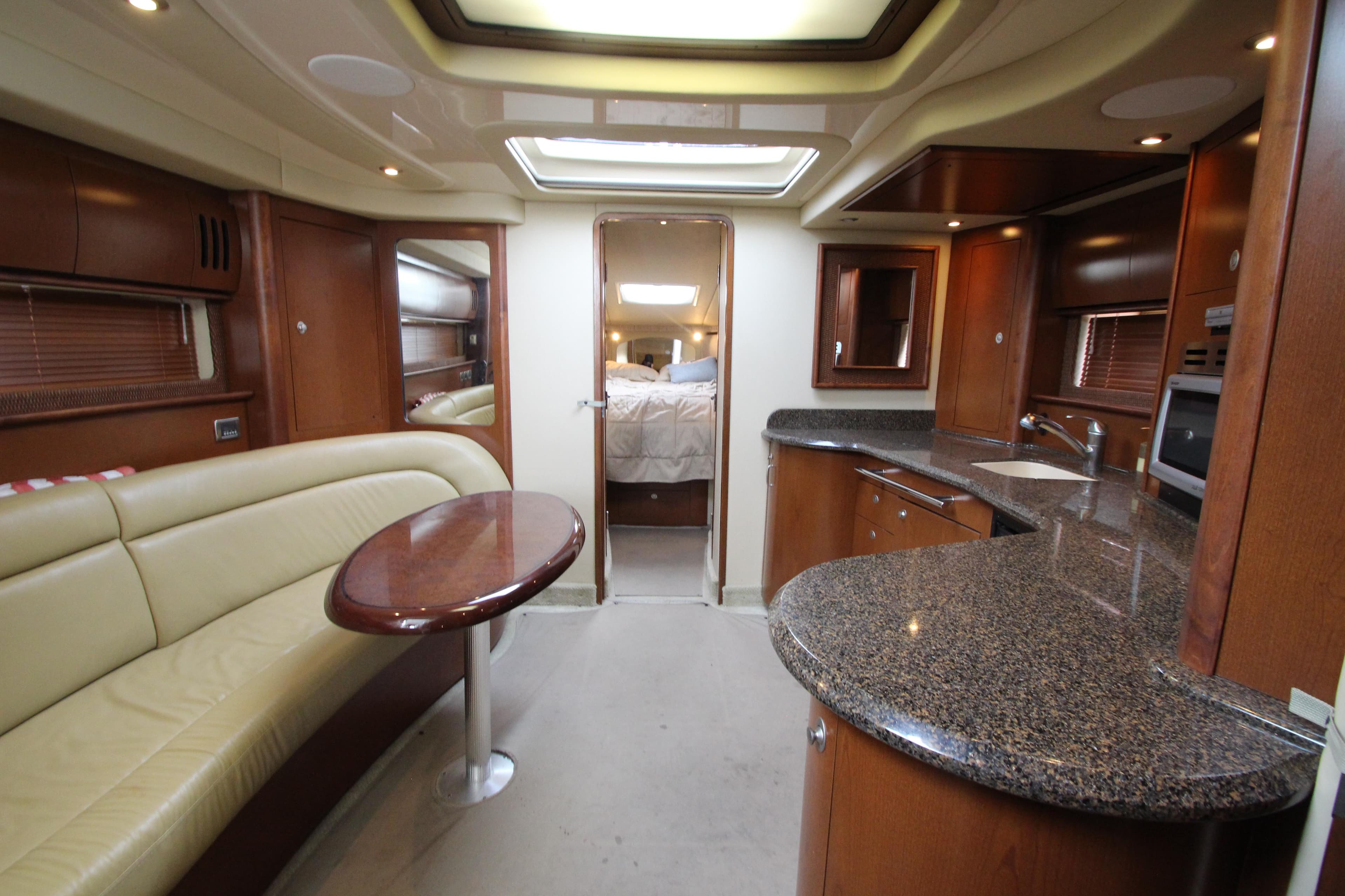 Luxurious interior of 2007 Sea Ray 44 Sundancer yacht with modern kitchen and seating area.