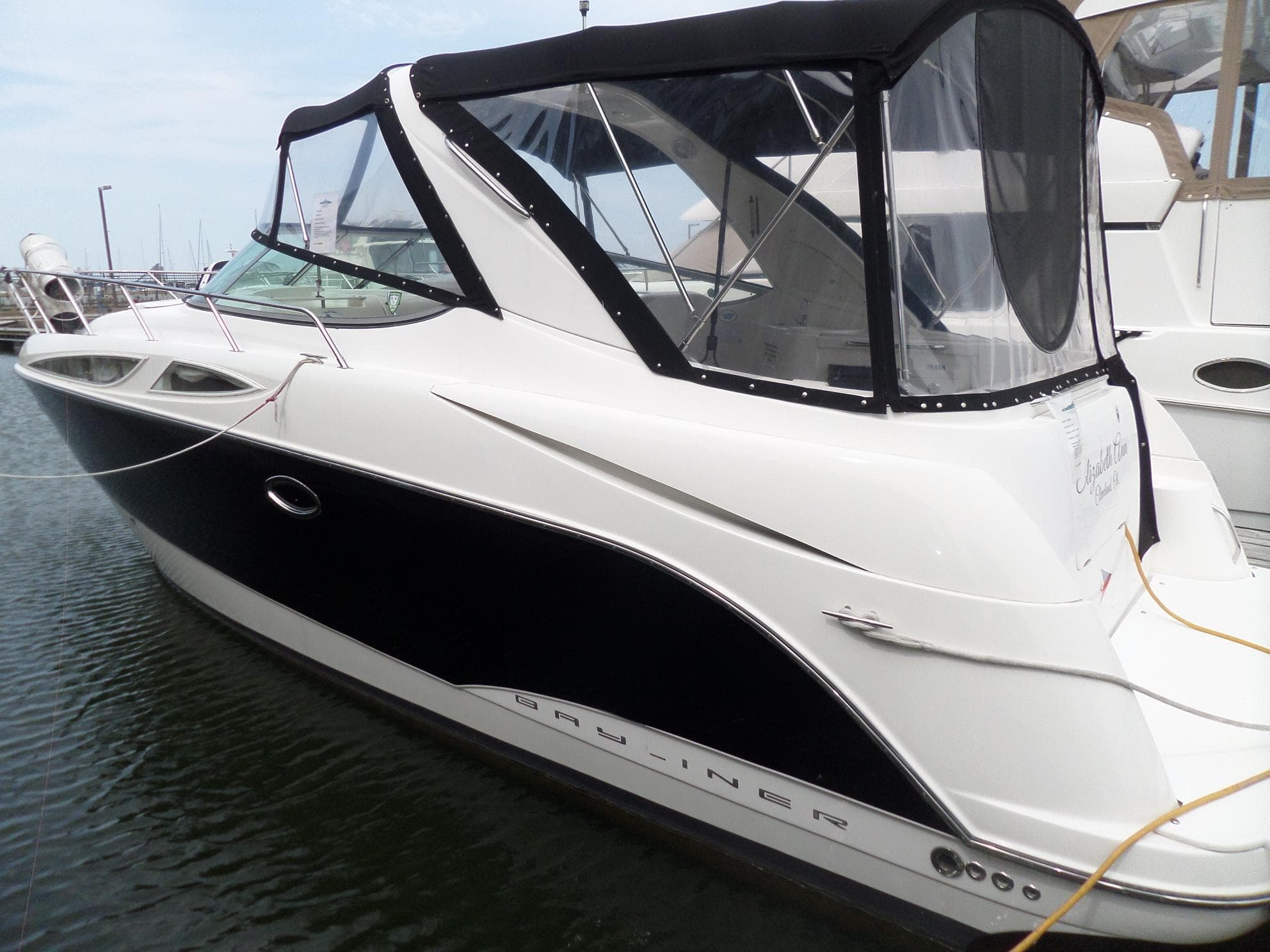 2008 Bayliner 320 Express boat docked in marina.