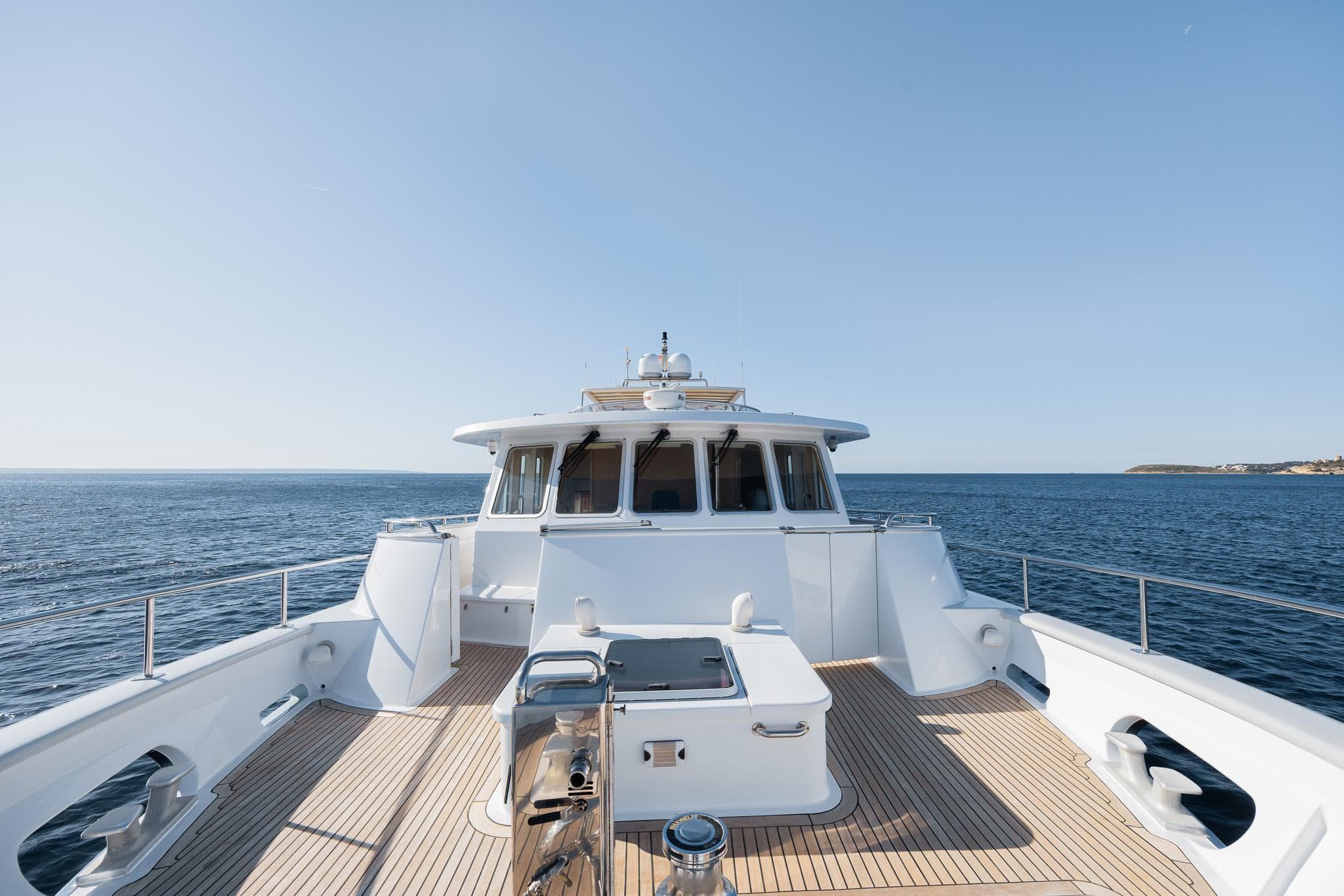 Custom 86' Carey Shipyard yacht, 2007 model, cruising on open sea under clear blue sky.