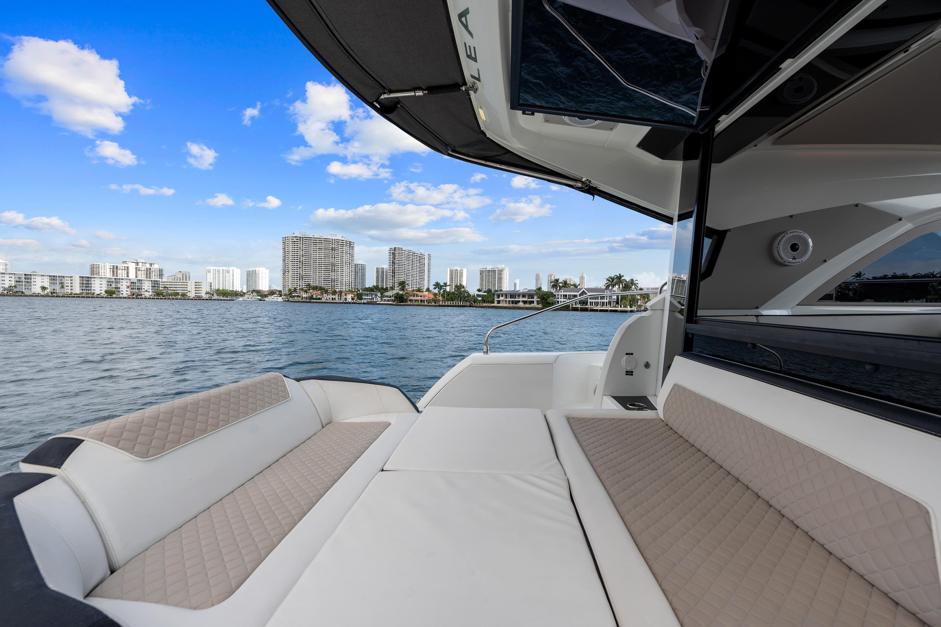 2018 Jeanneau Leader 46 yacht with spacious deck, city skyline in background.