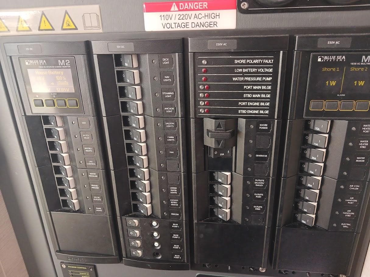 Electrical panel with switches and warning labels, Leopard 50 model, 2020.