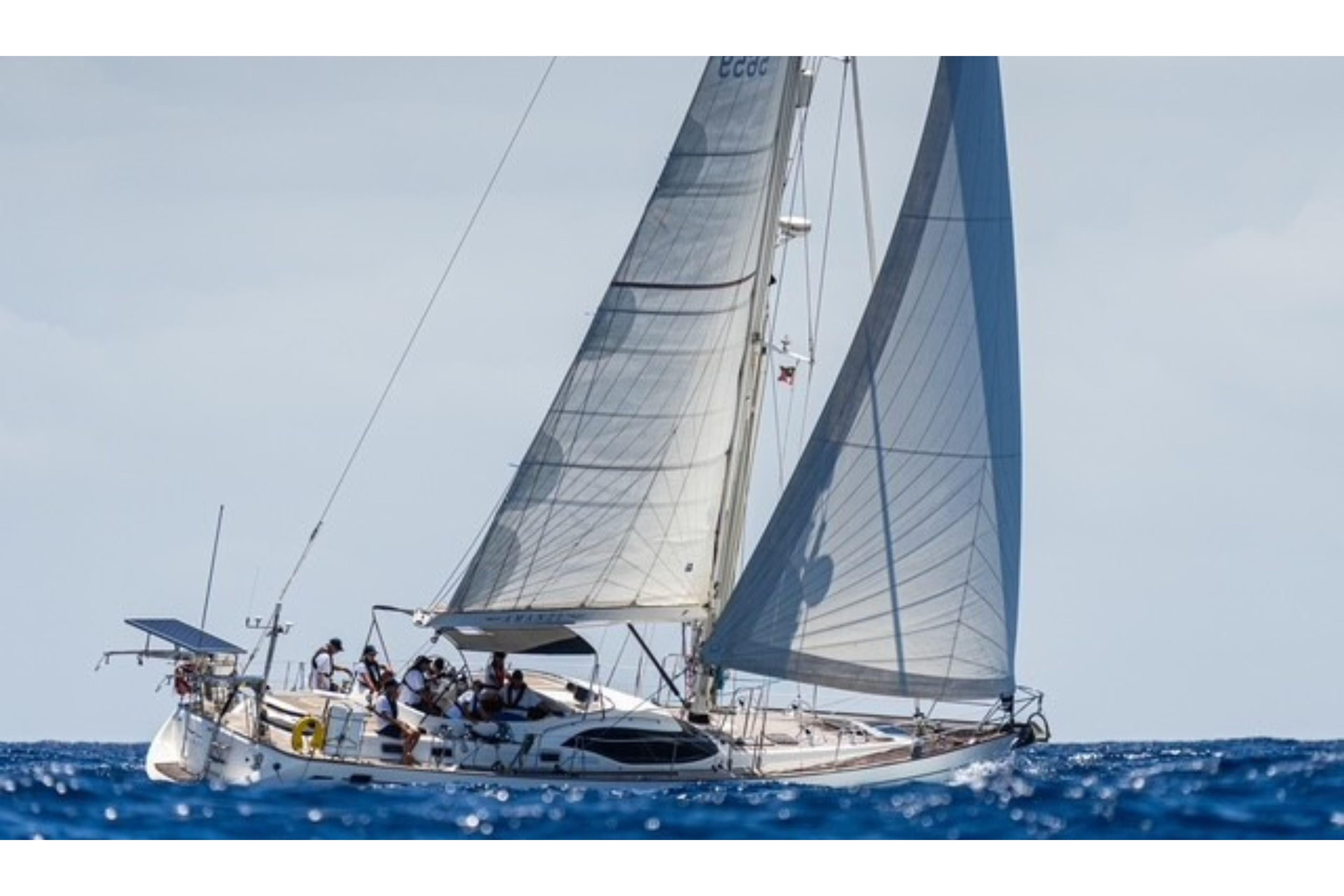 Sailing yacht Oyster 56, 2007 model, gliding on open sea with full sails.