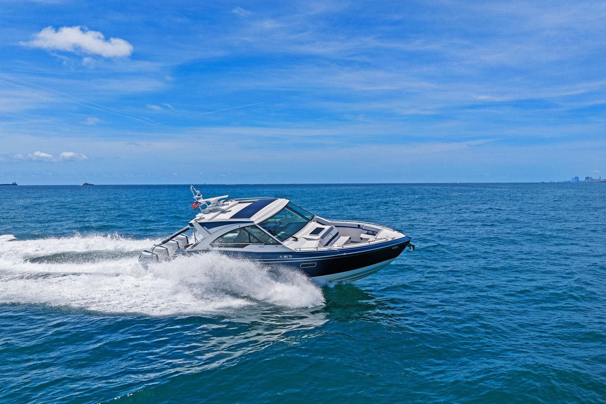 2025 Formula 400 Super Sport Crossover cruising on open ocean under clear blue sky.