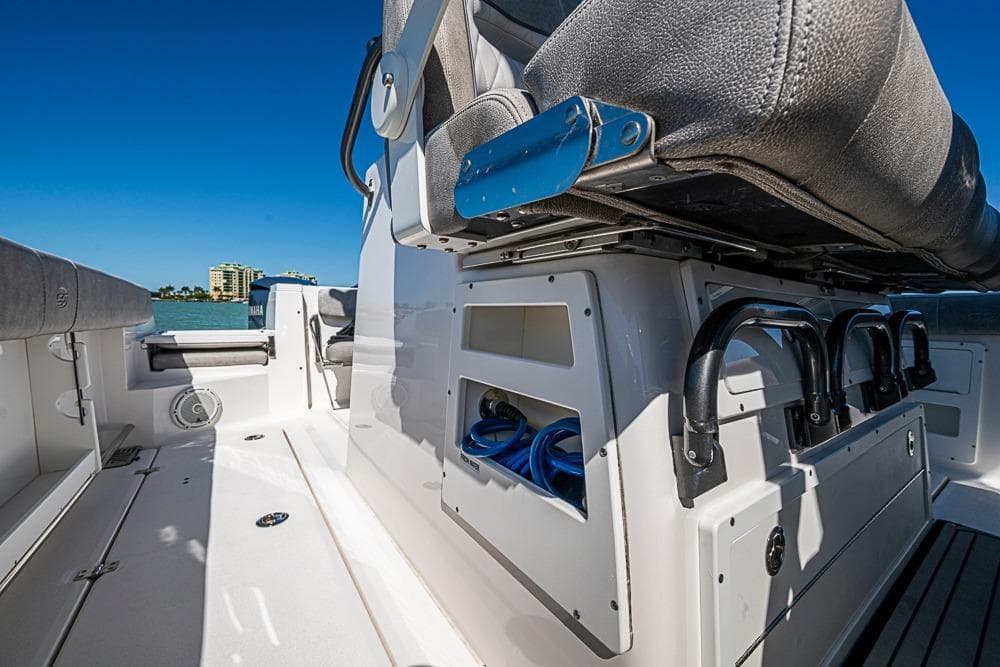2018 Sea Fox 328 Commander boat interior with seating and storage, under clear blue sky.