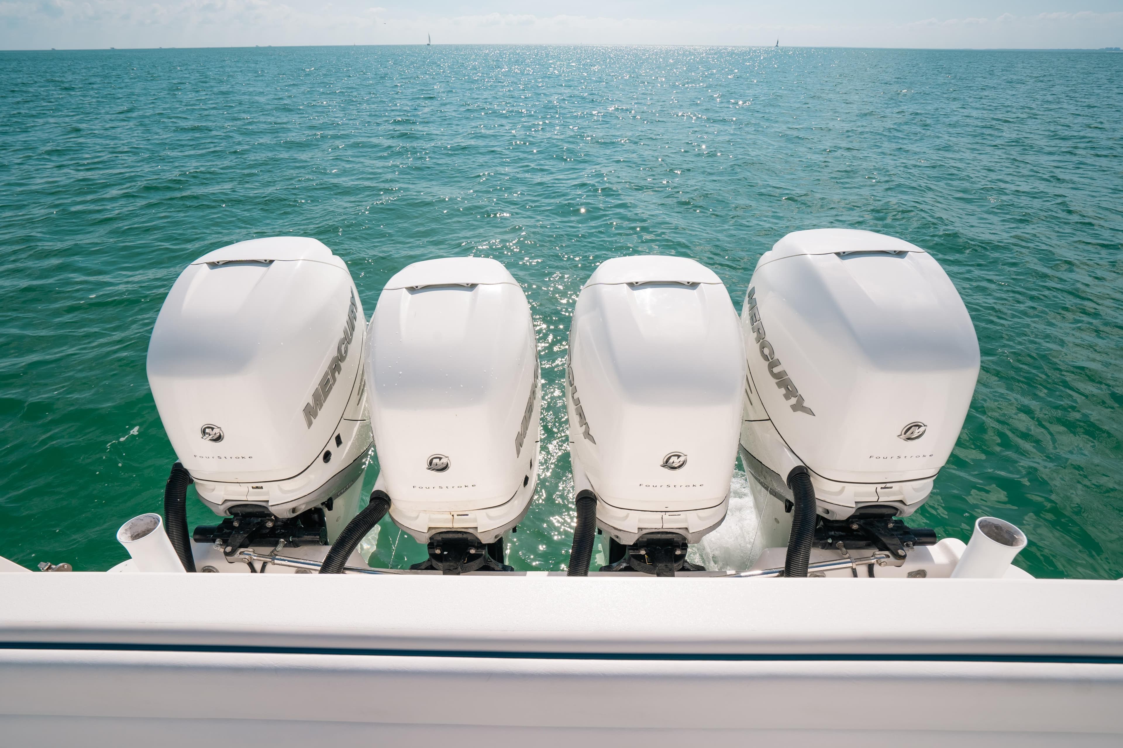 Four Mercury outboard engines on a 2009 Intrepid 475 Sport Yacht in open water.