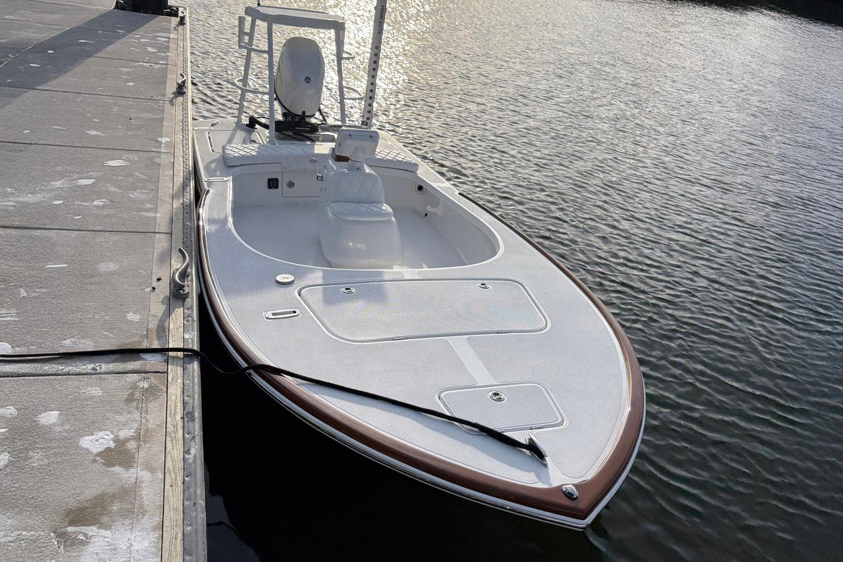 2026 Chaos 16 Bonefish boat docked on calm water.