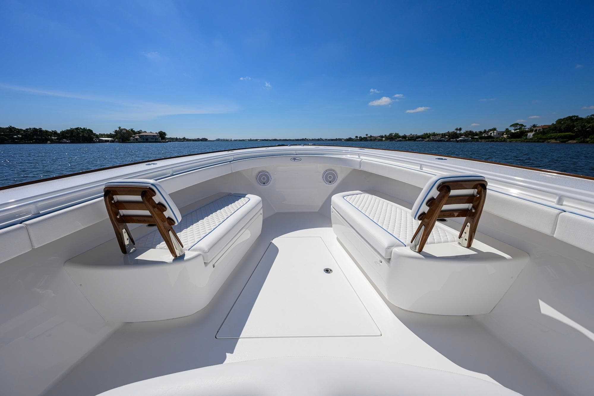 2025 Valhalla Boatworks V-41, spacious deck with seating, on a sunny day by the water.