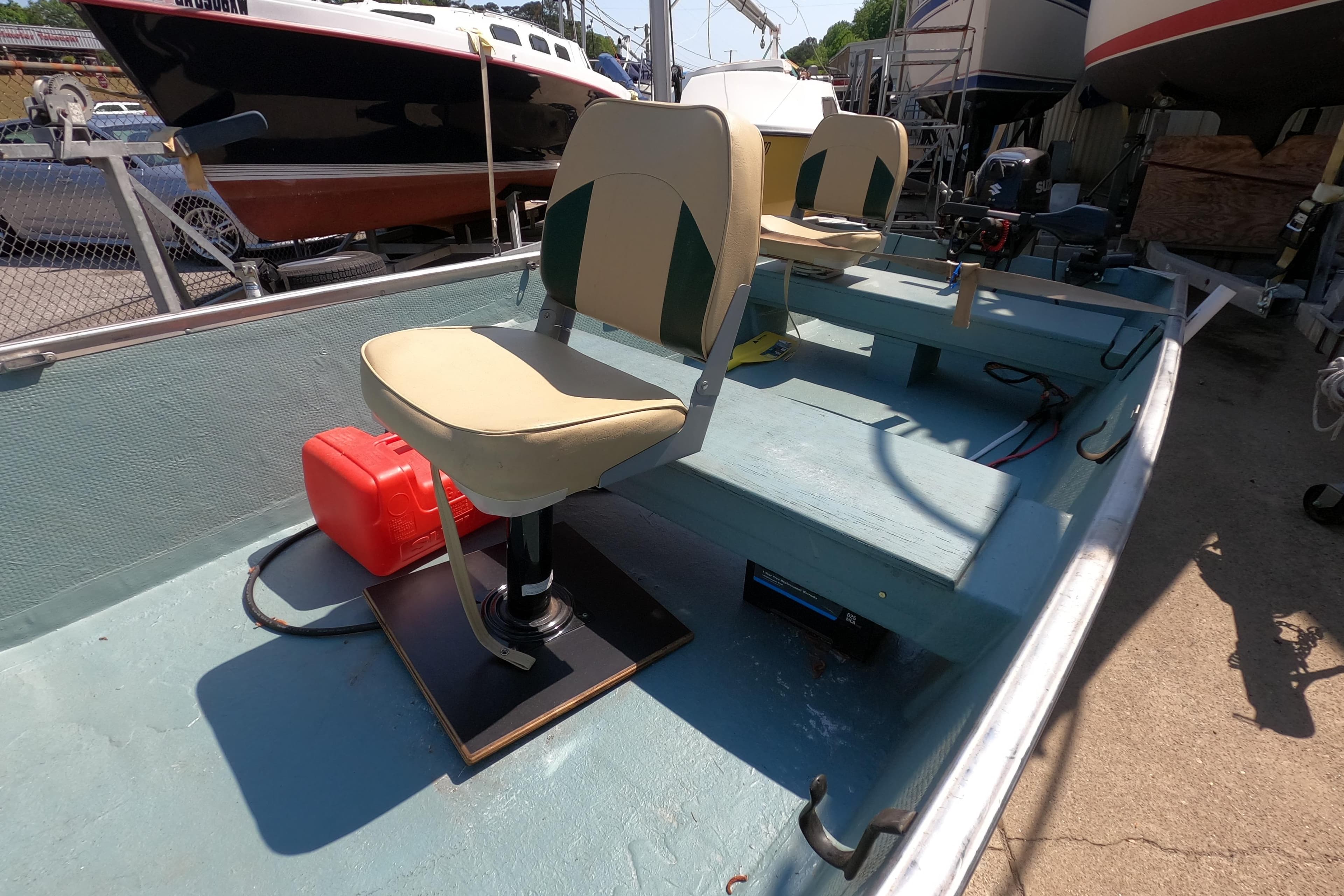 1969 Thundercraft 14 boat interior with seating and equipment, docked outdoors.