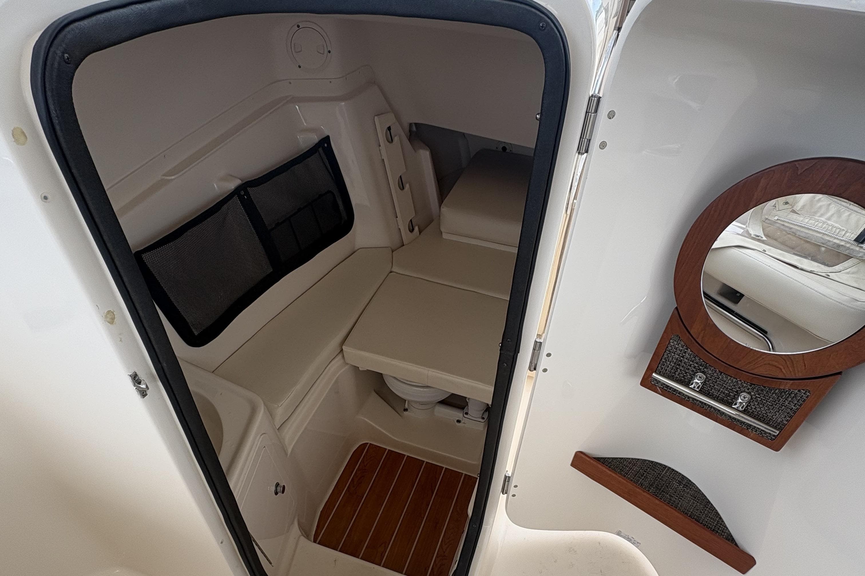 2020 Grady-White Freedom 307 cabin interior with seating, mirror, and storage.