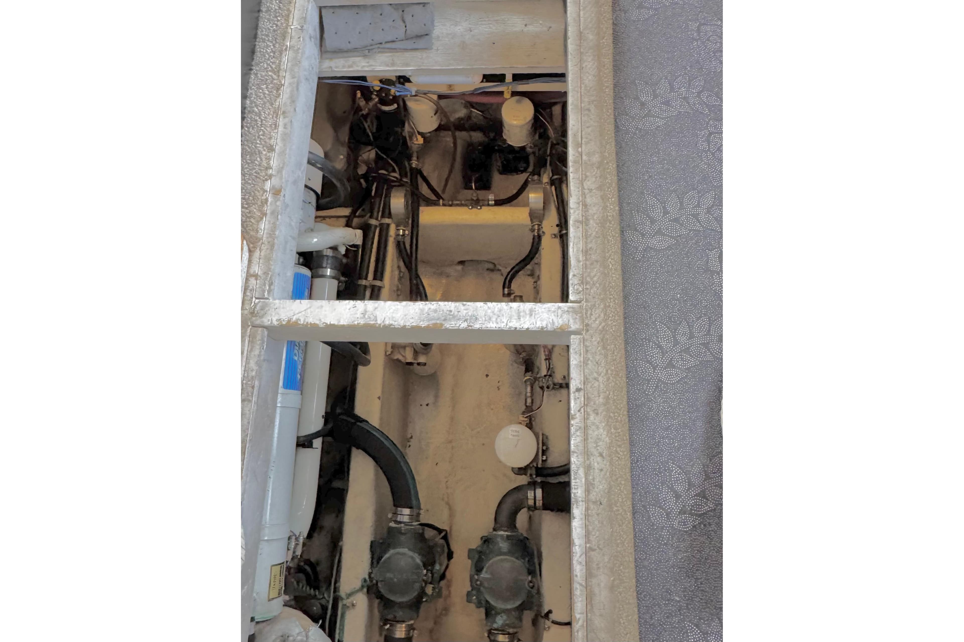 Engine compartment of 1999 Bayliner 4087 Aft Cabin Motoryacht, showcasing mechanical components.
