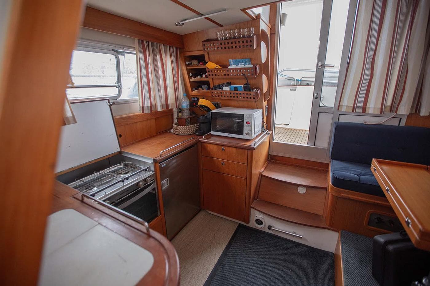 Interior of 2005 Nimbus 380 Commander boat with kitchen and seating area.