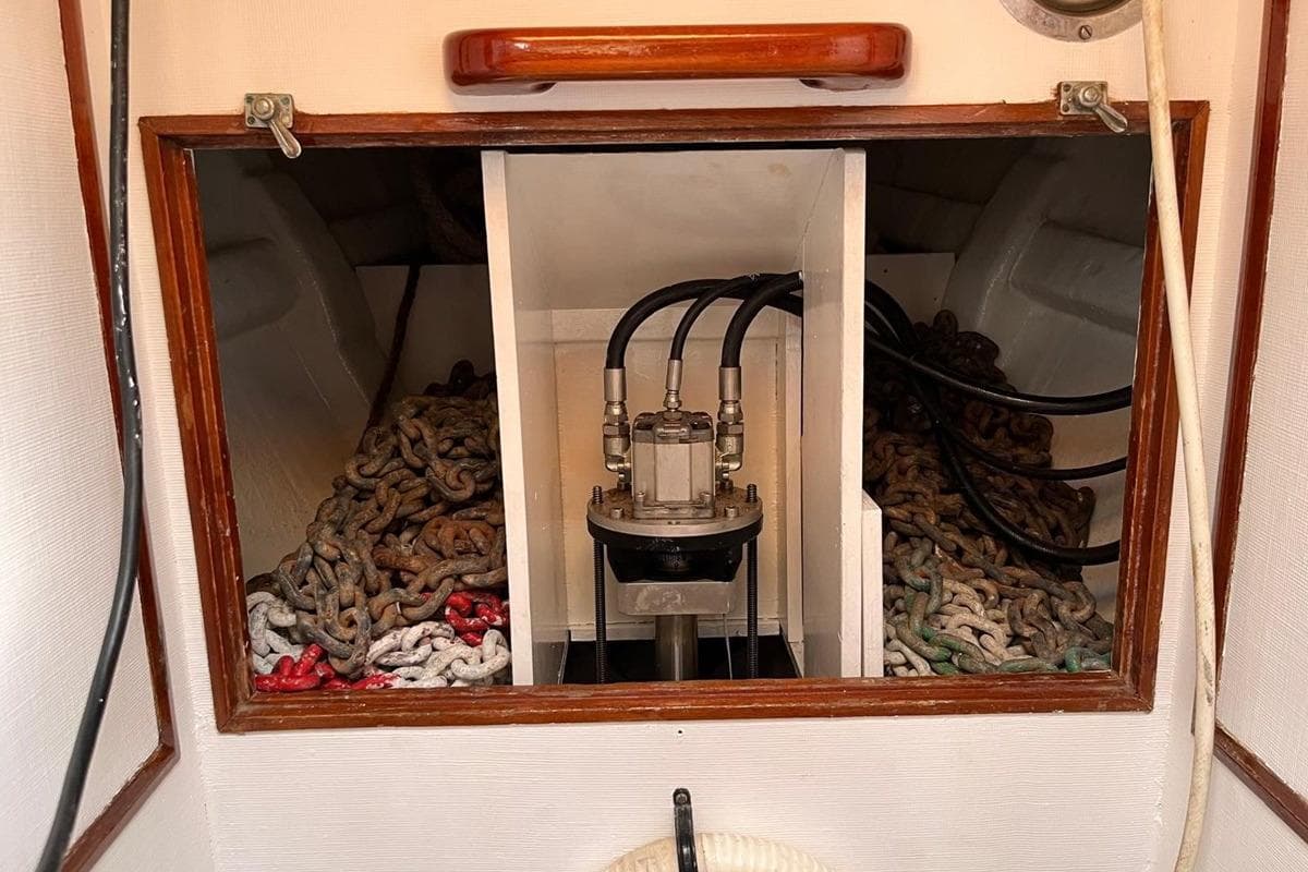 Interior of a 1978 Bowman 66 boat showing anchor chains and hydraulic system.