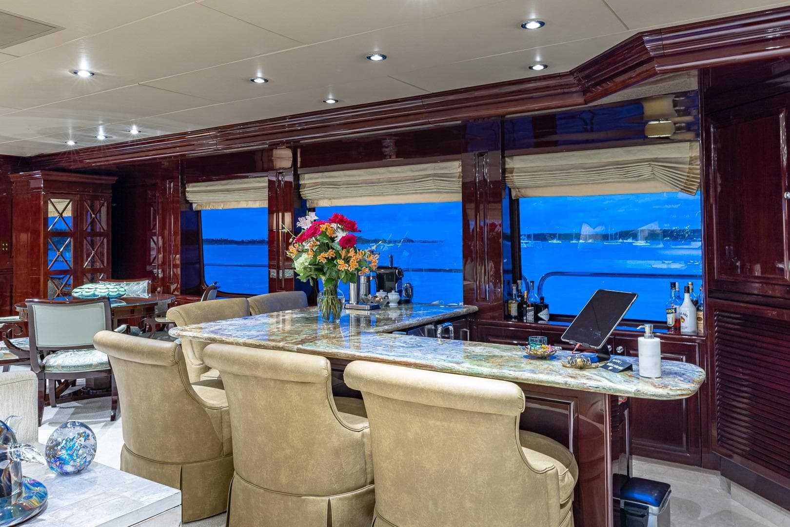 Luxurious interior of 2007 Christensen Tri-Deck yacht with elegant bar and ocean view.