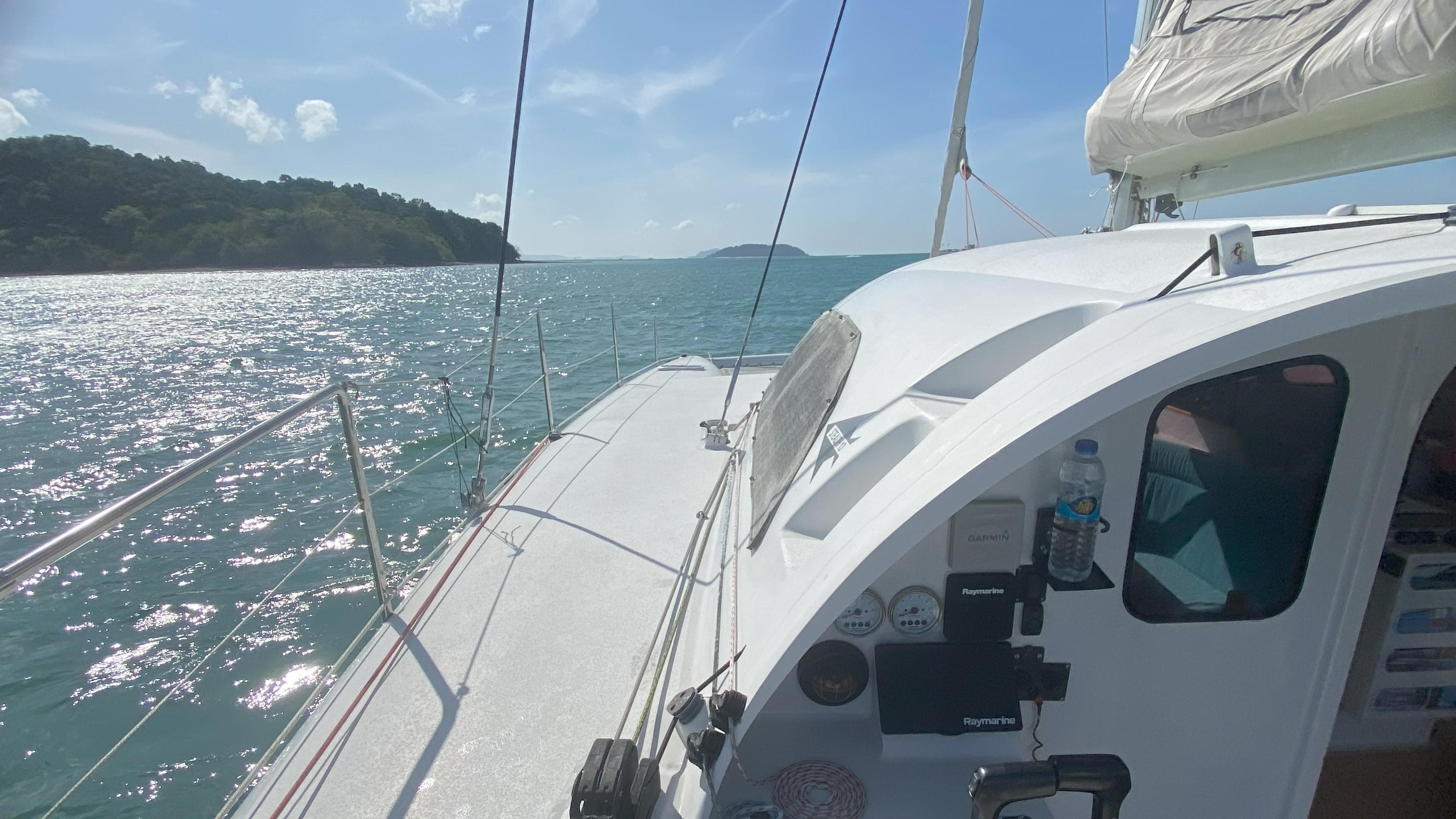 Sailing on a 2016 Stealth 13C catamaran in sunny, scenic waters.