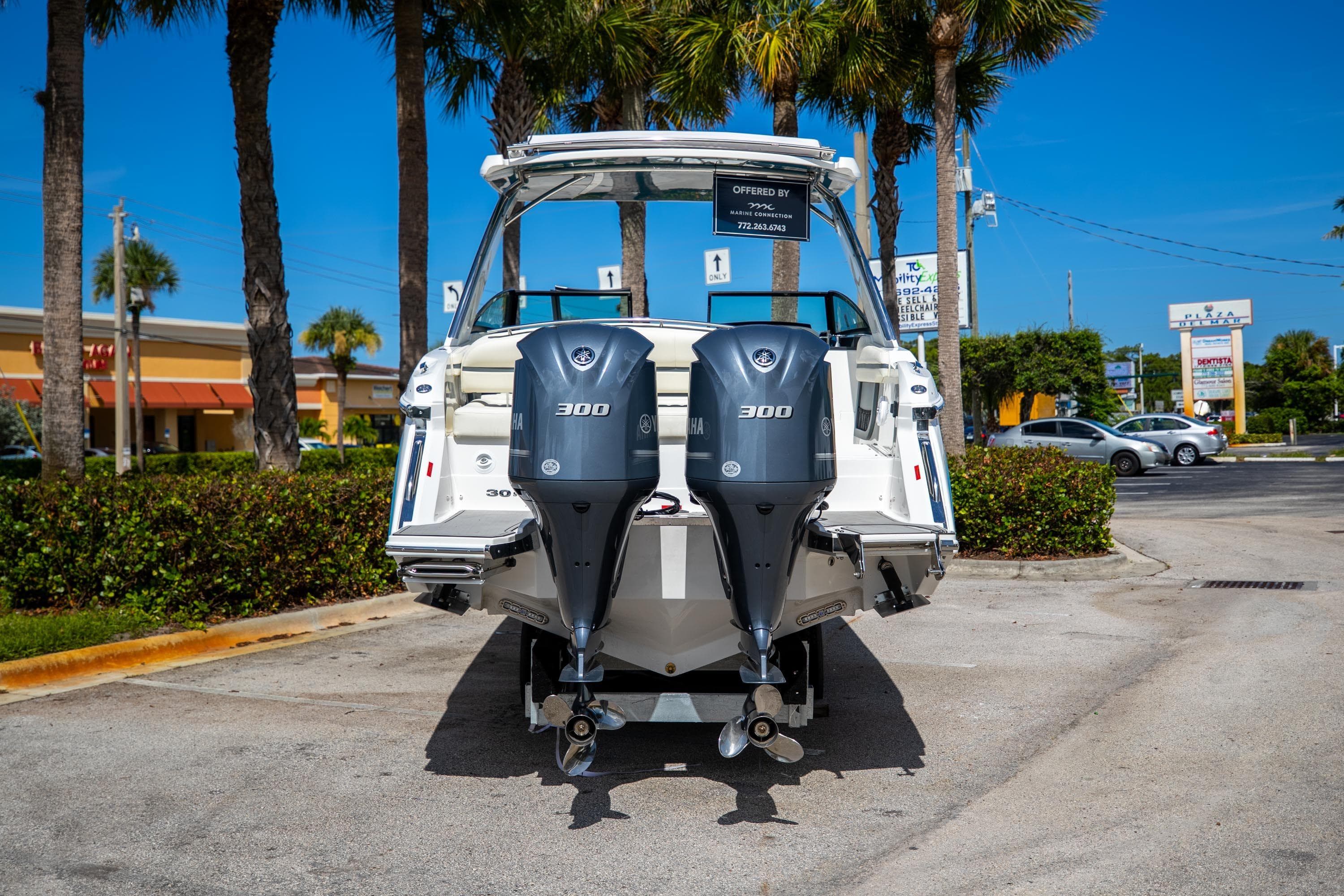 2022 Cobalt 30SC boat with dual 300 horsepower engines, parked outdoors on a sunny day.