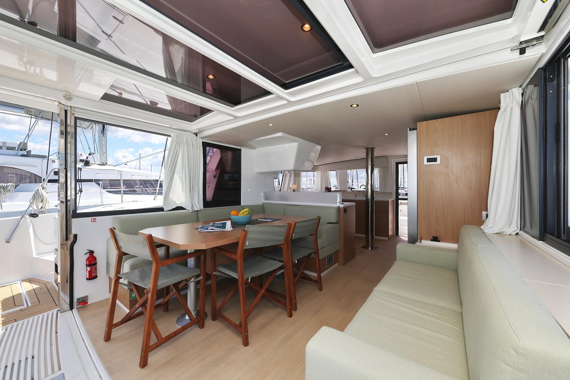Luxurious interior of 2025 Bali 4.4 yacht with dining area and seating.