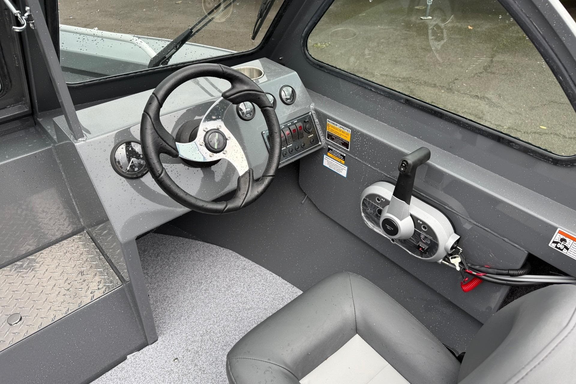 Interior of 2026 Fish Rite Sportsman 20 boat, featuring steering wheel and control panel.