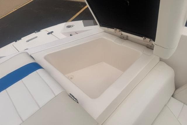 2007 Regal 2200 Bowrider boat storage compartment with open lid, showcasing interior space.