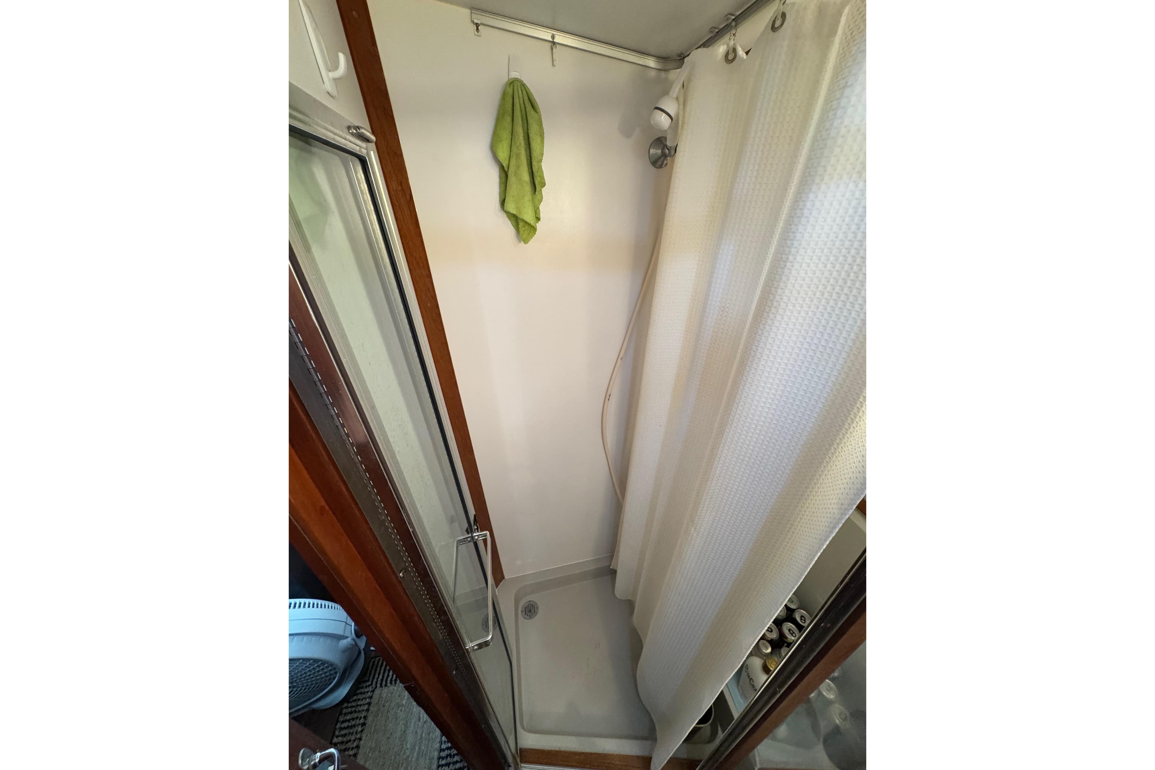 Shower area in 1986 Carver 42 Aft Cabin Motor Yacht with curtain and towel.