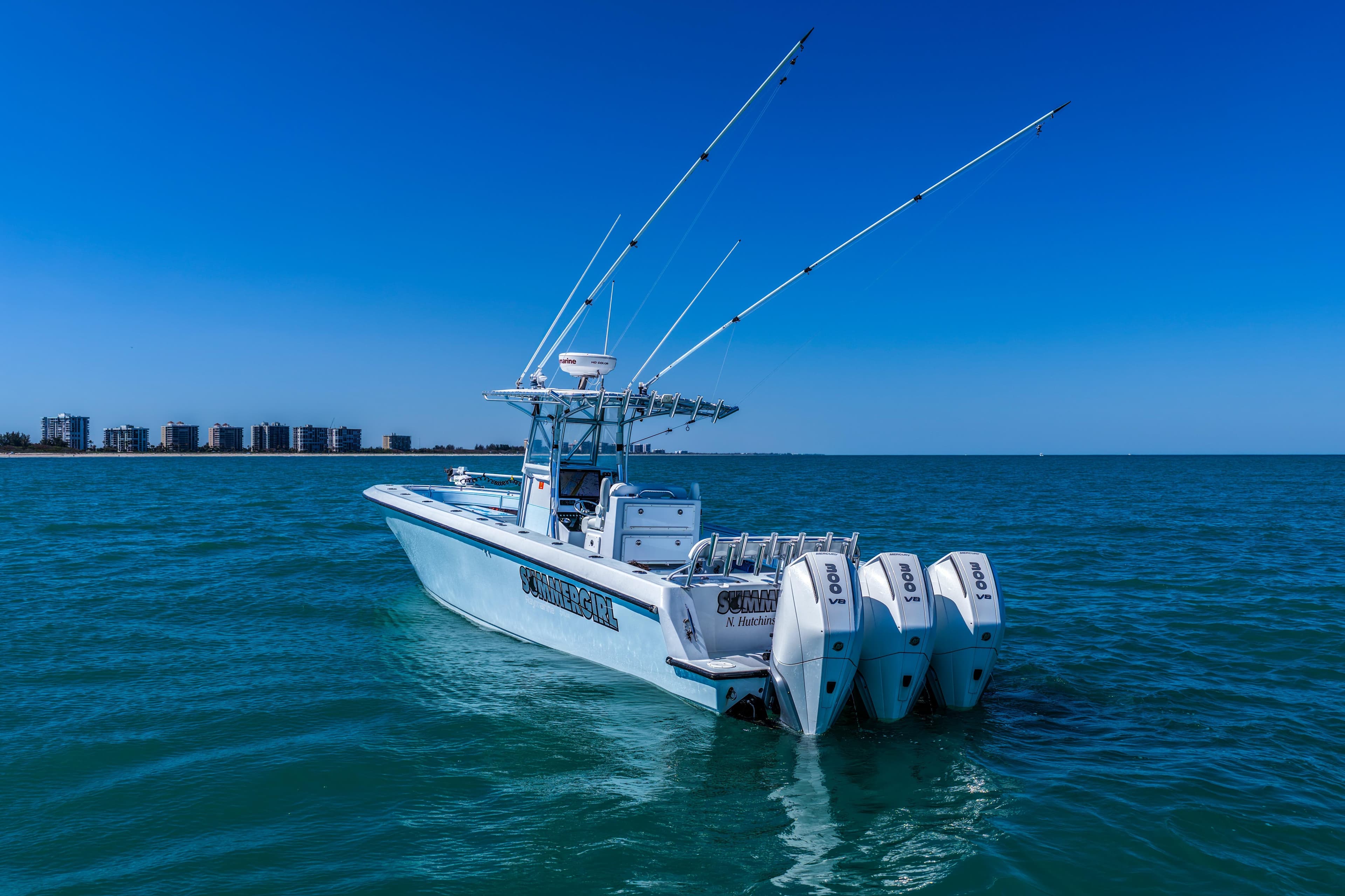 2003 Contender 36 Open boat with four engines on blue ocean water.