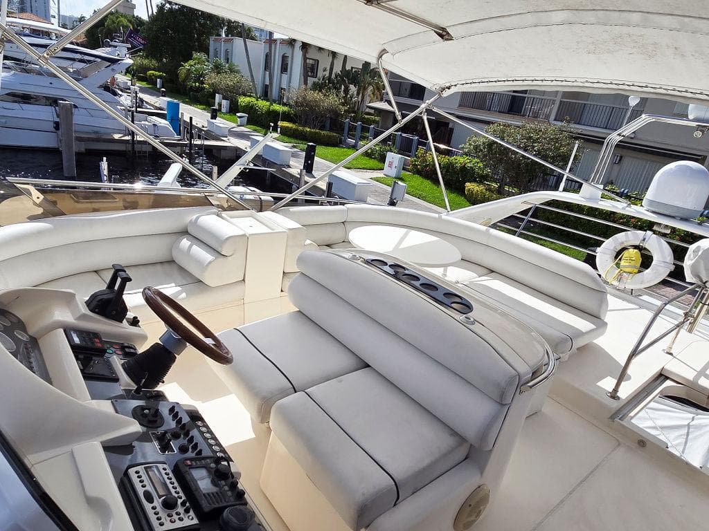 1998 Viking Princess 56 Sport Cruiser yacht interior with luxurious seating and control panel.