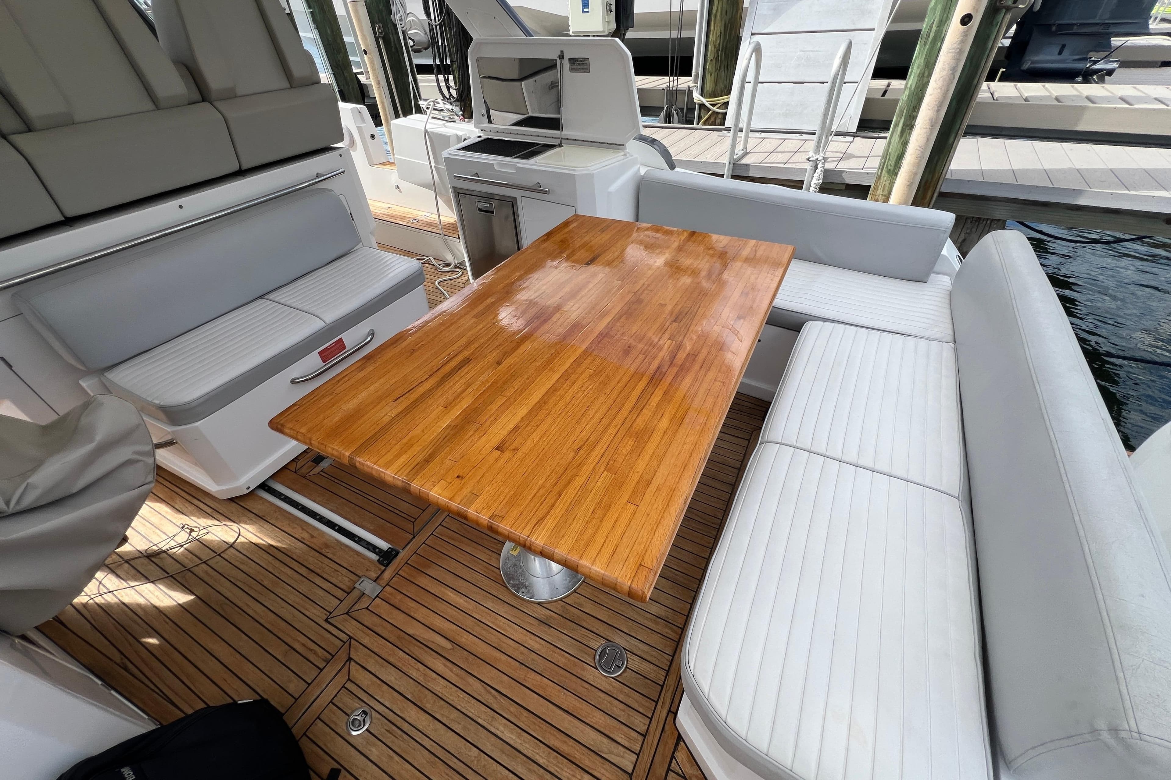 2018 Azimut Verve 40 yacht interior with wooden table and white seating.