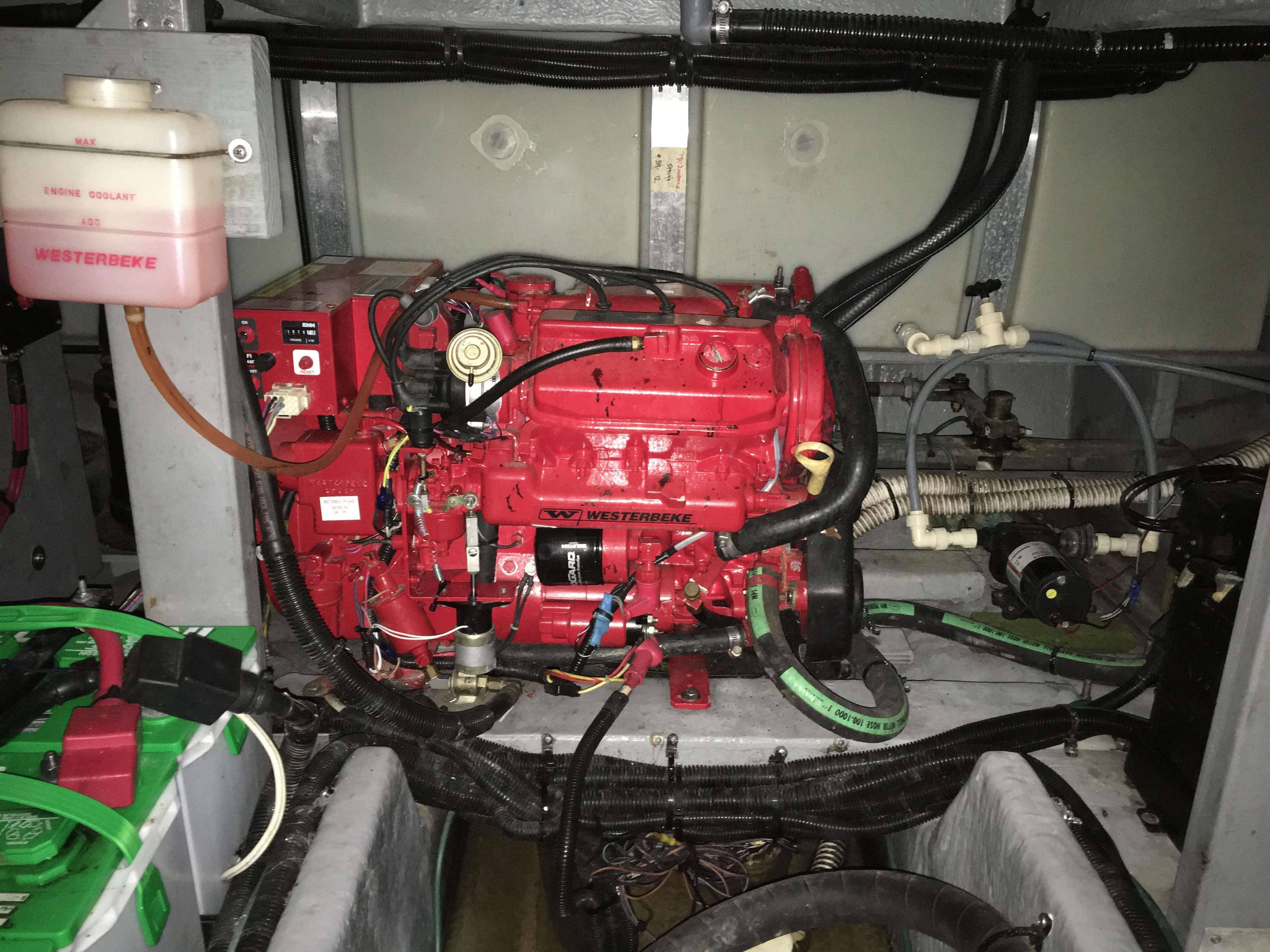 Engine room of a 1996 Sea Ray 400 Express Cruiser with a red Westerbeke generator.