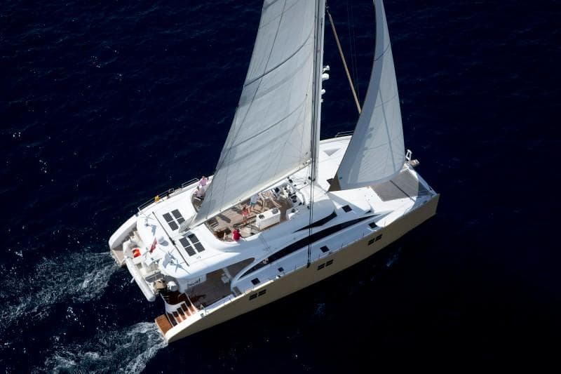 Luxury Sunreef 82 DD catamaran sailing on open sea, 2012 model.