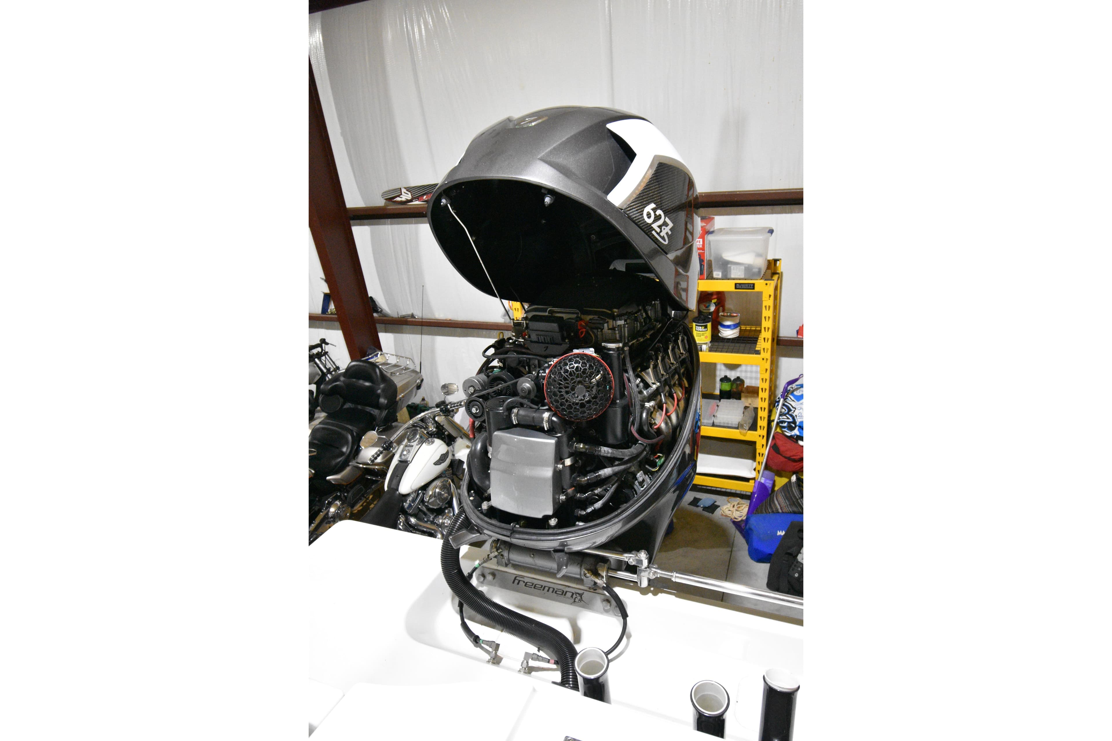 Open engine of a 2016 Freeman 37VH boat in a garage setting.
