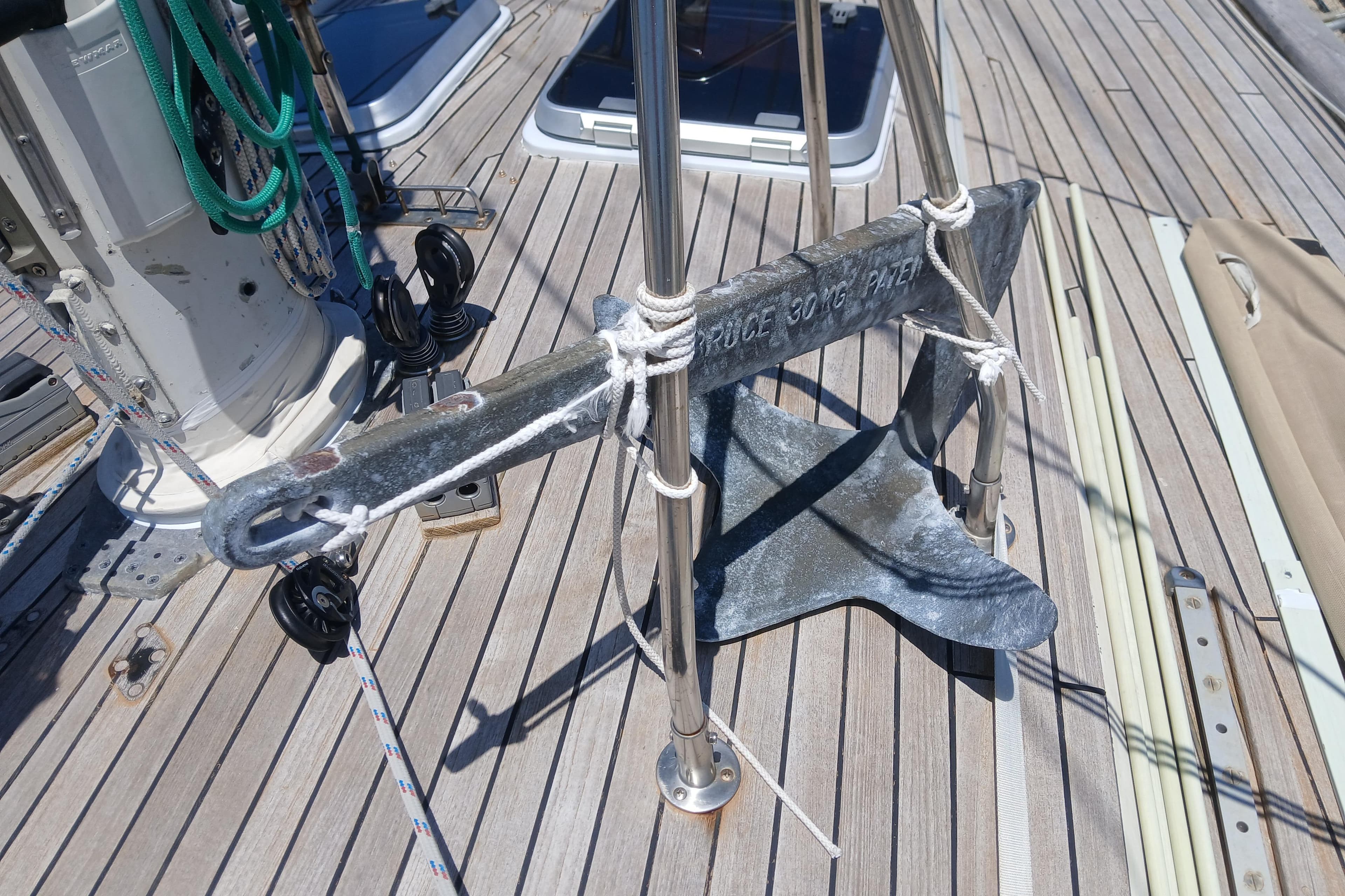 Anchor on deck of 1981 Kaufman Skye 51 sailboat, secured with ropes.