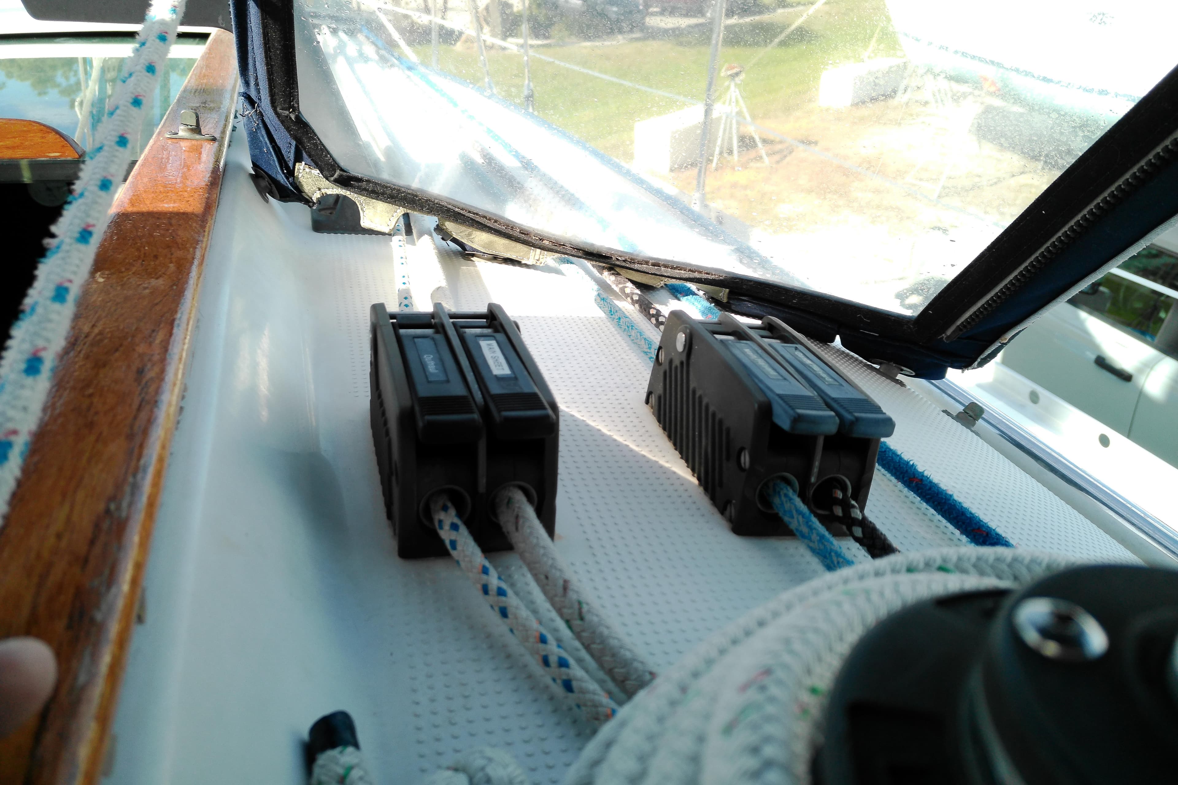 Deck view of a 1993 Beneteau First 310 sailboat with rope clutches.