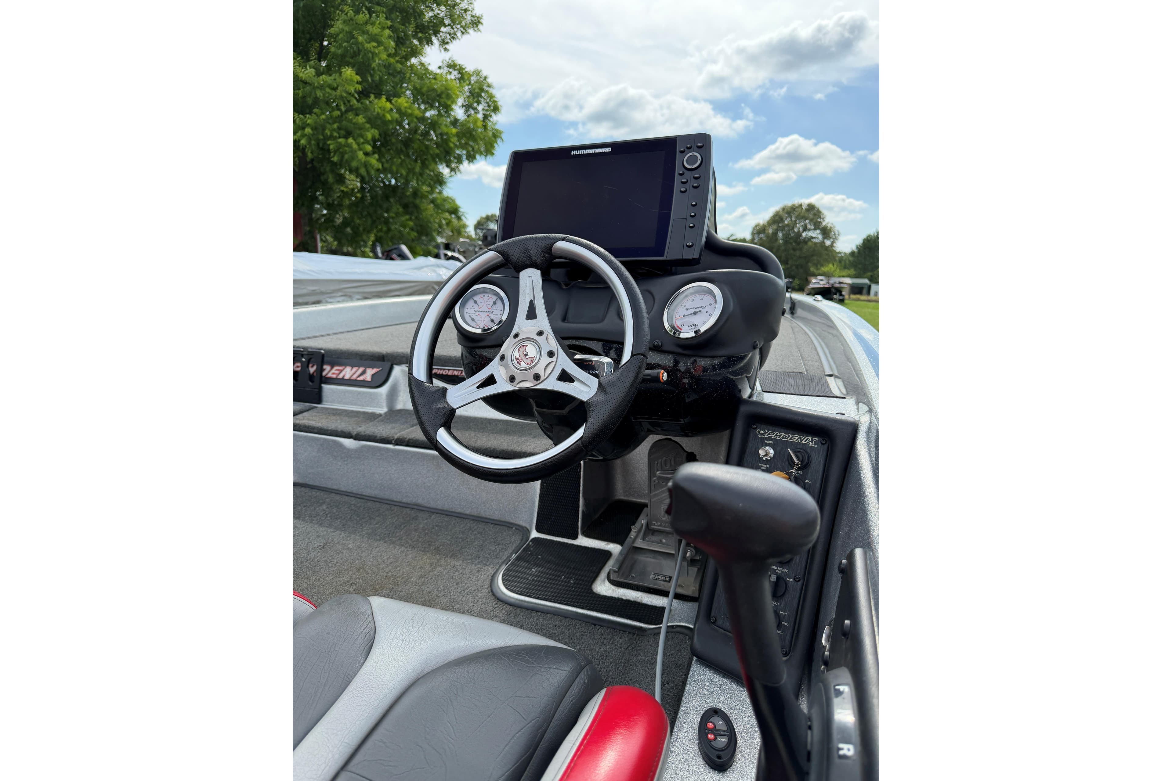 2019 Phoenix 920 ProXP boat dashboard with steering wheel and navigation display.
