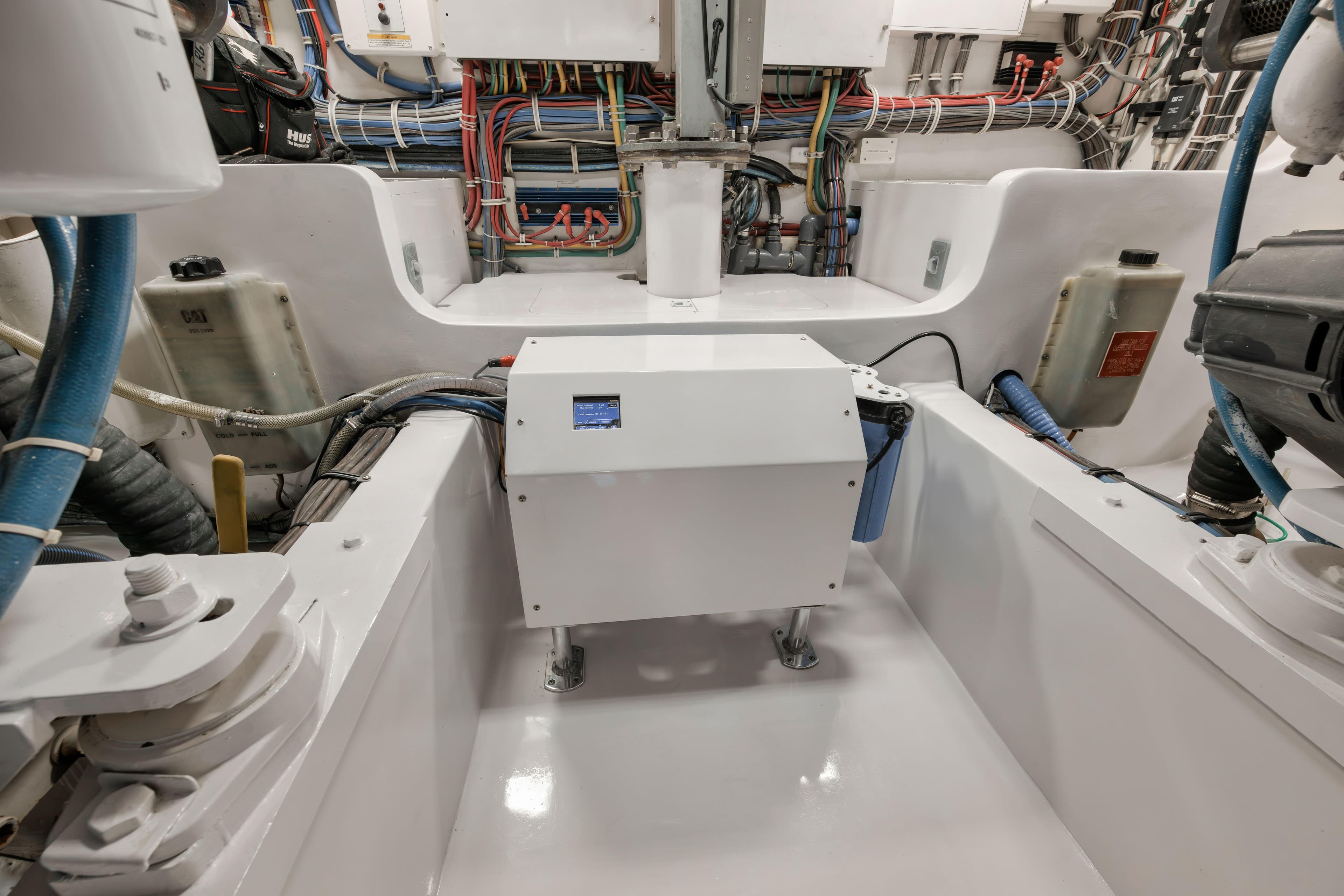 Engine room of 2009 Hatteras 60GT yacht, showcasing wiring and equipment.