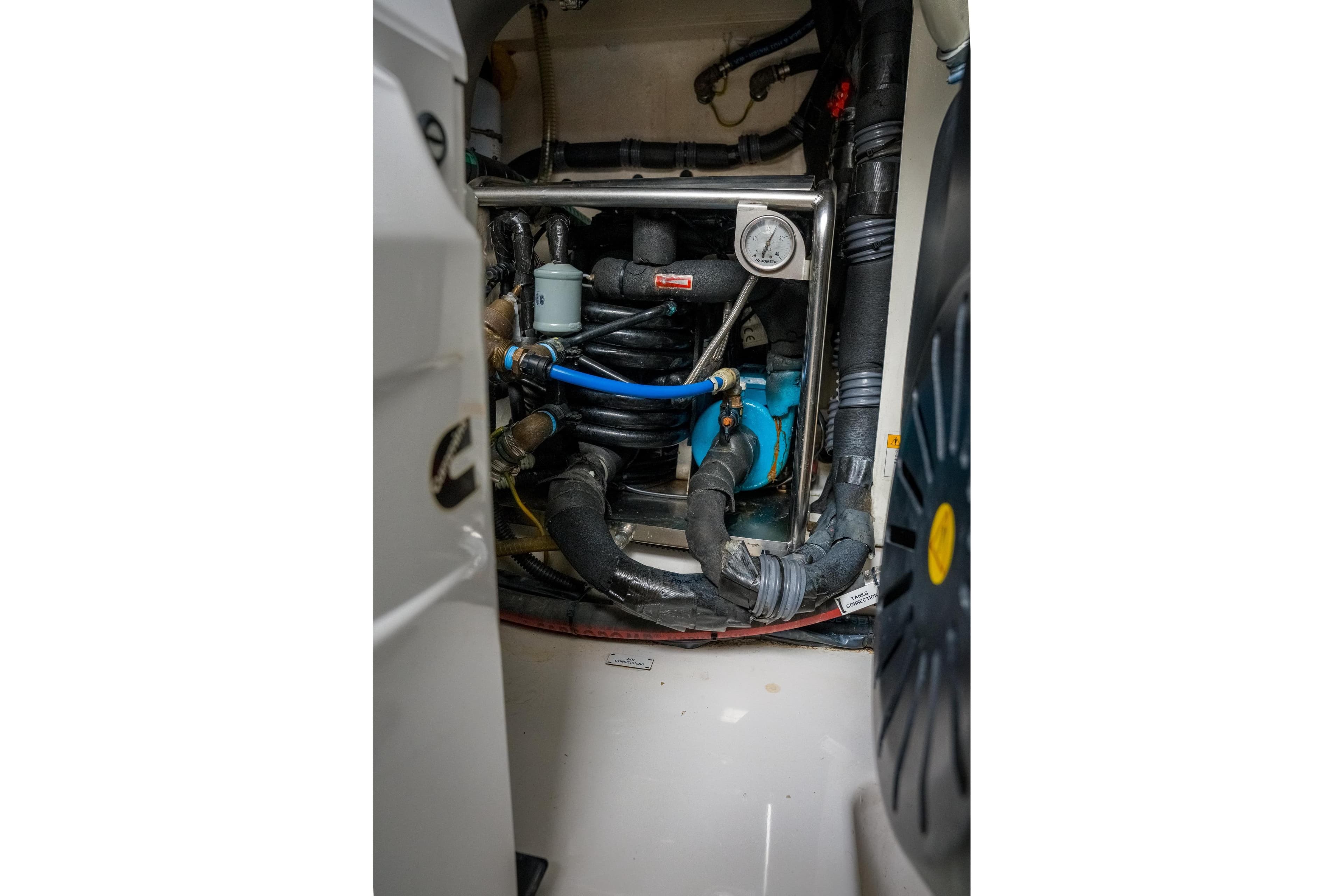 Engine room of 2019 Azimut Fly 50 yacht with visible machinery and hoses.